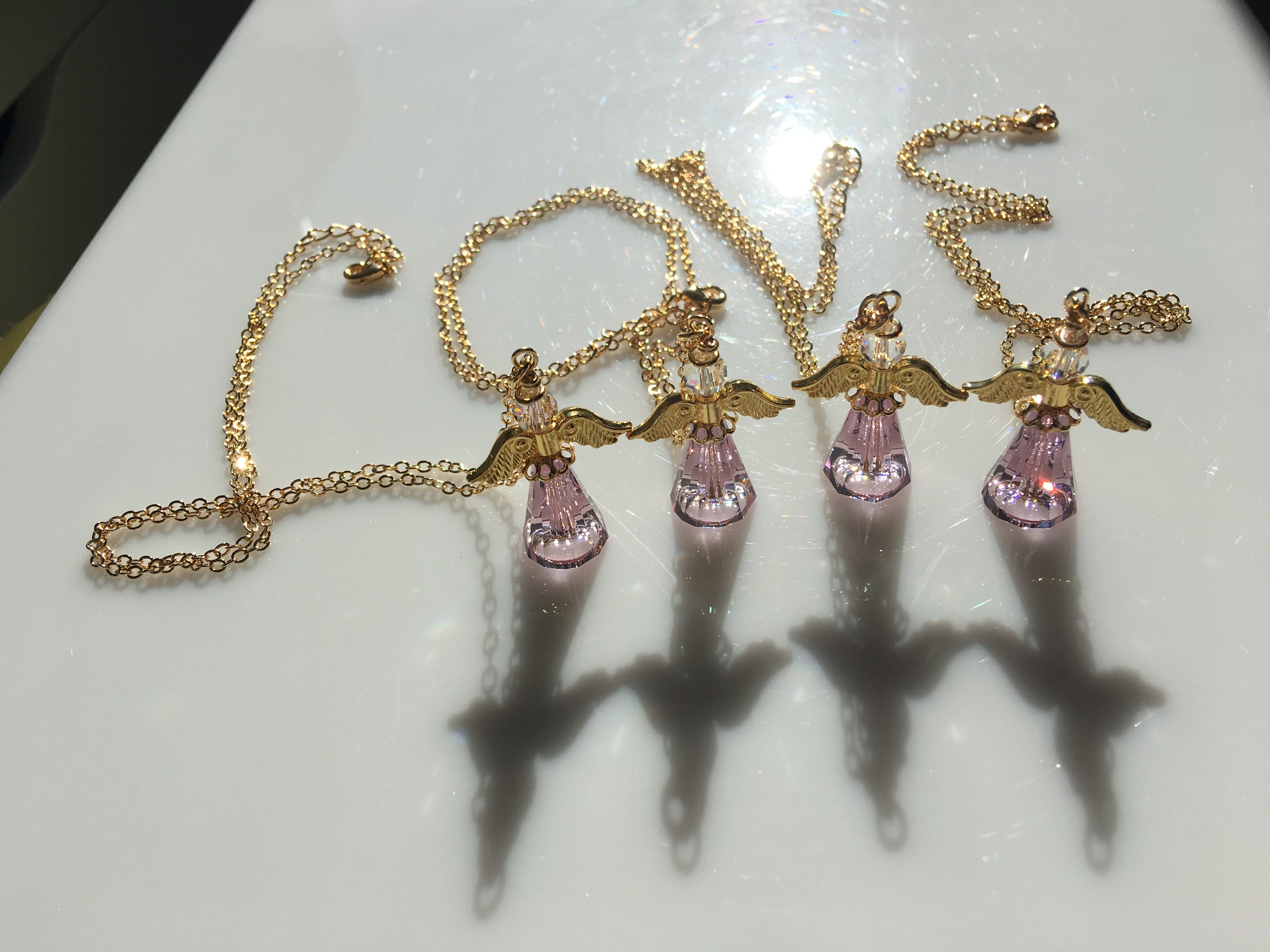Large pink angel necklaces