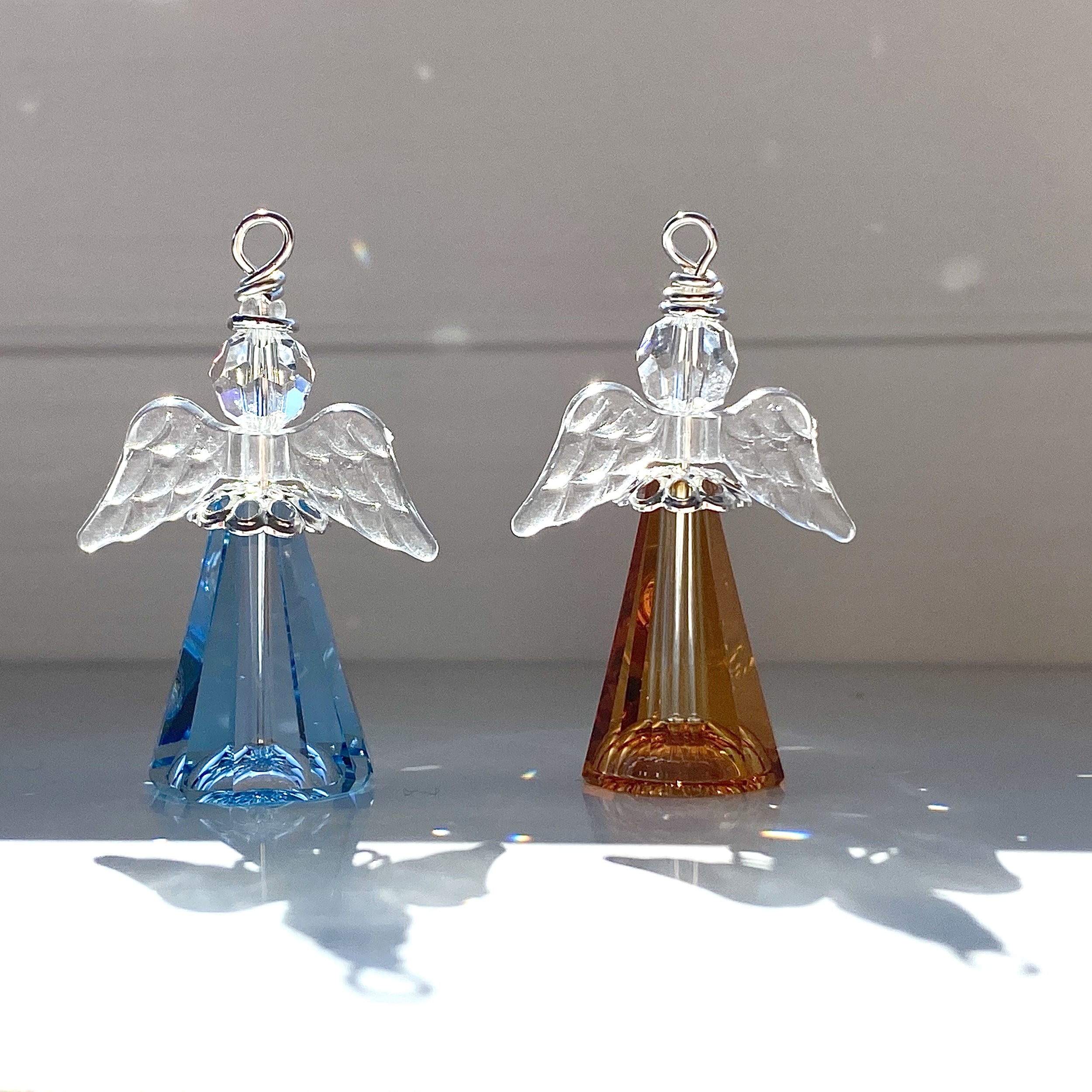 Large light blue and sunset angels with clear wings