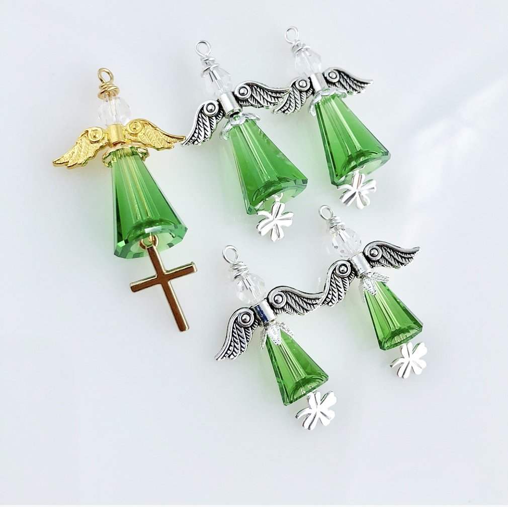 Large green angel with cross and small green angels with 4-leaf clovers