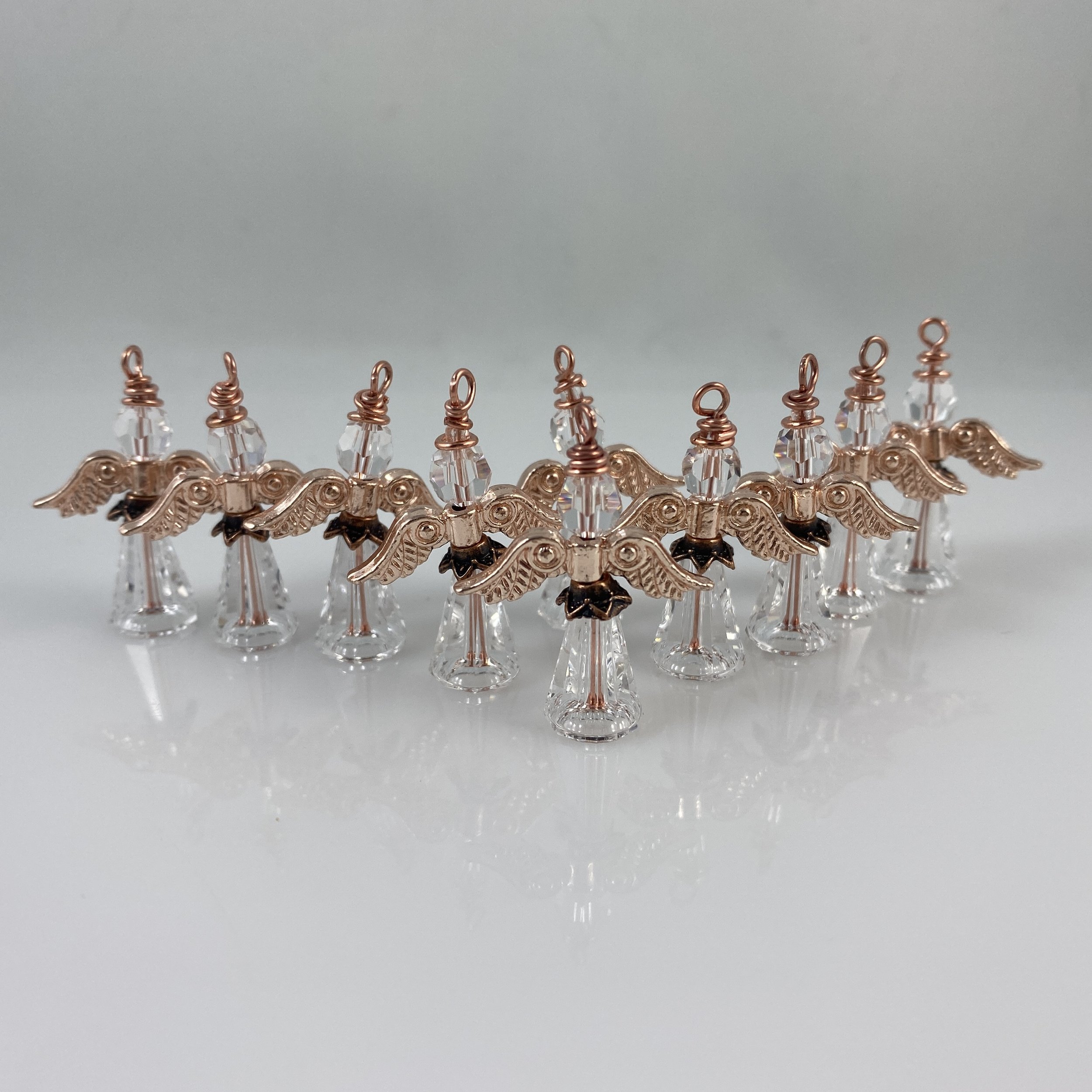 Large clear angels with rose gold wings