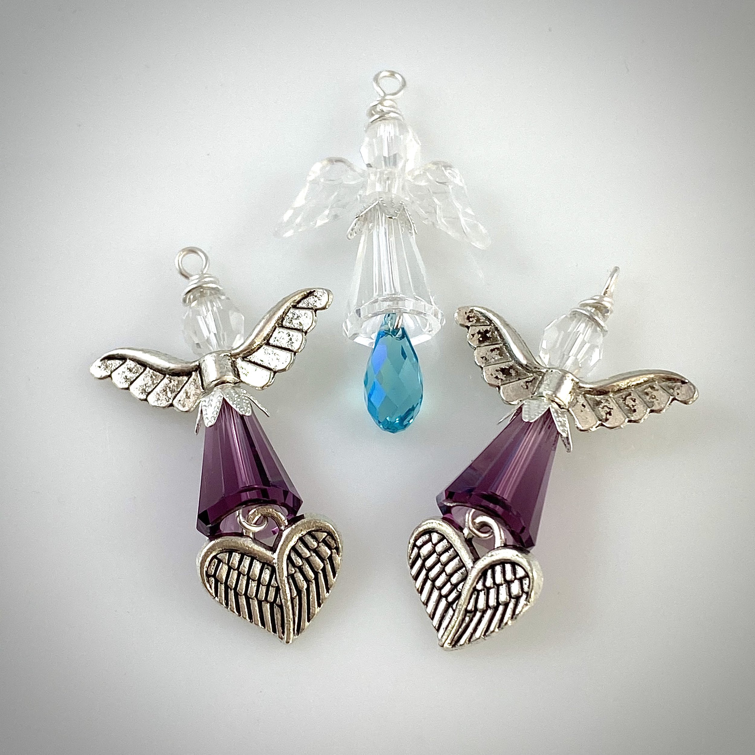 Small purple angels with heart wing charms and a PTSD angel