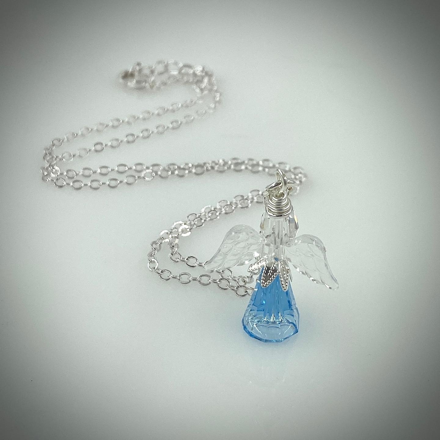 Large light blue angel with clear wings with a necklace chain