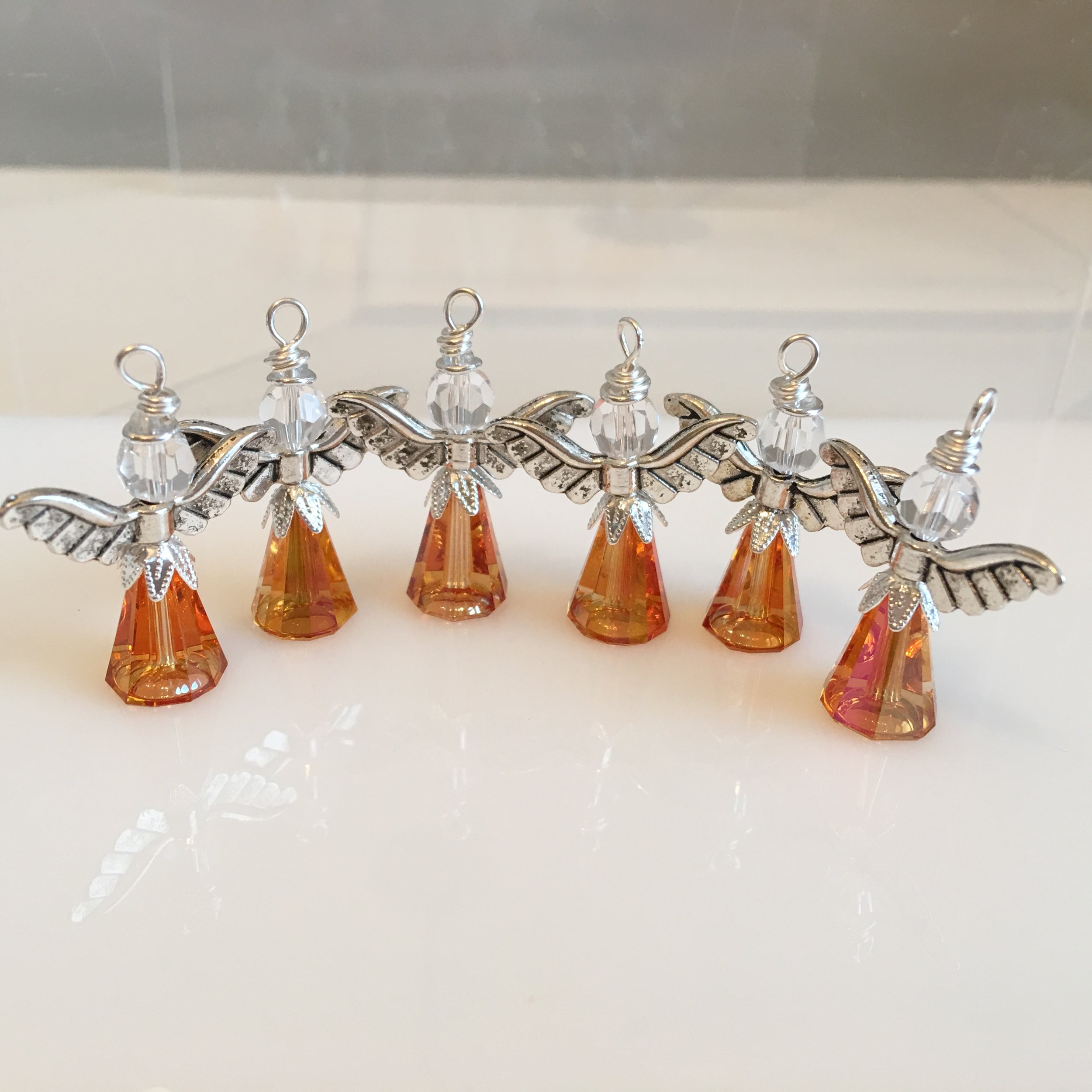 Small sunset angels with silver wings