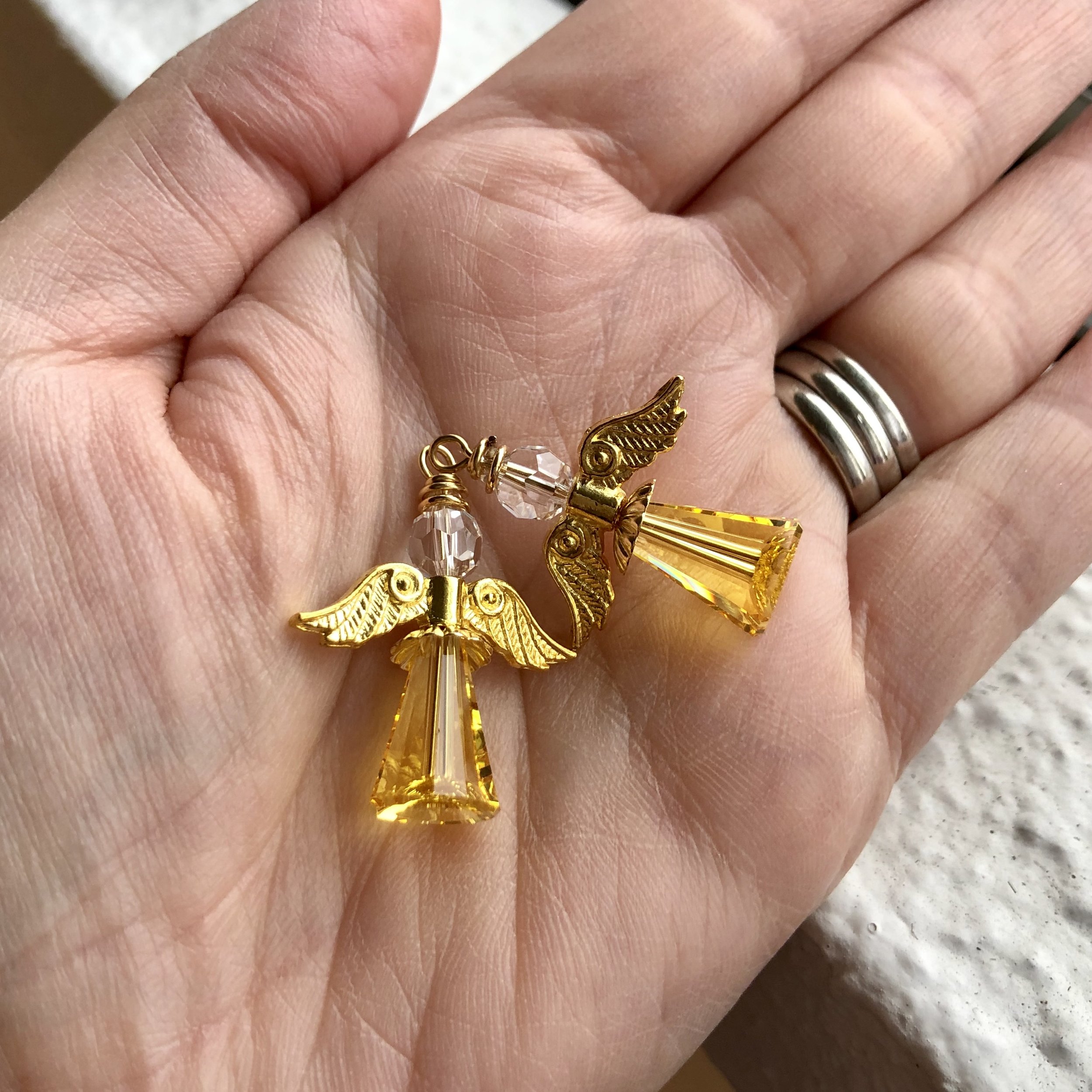 Matching pair of sunset coloured angels with gold wings