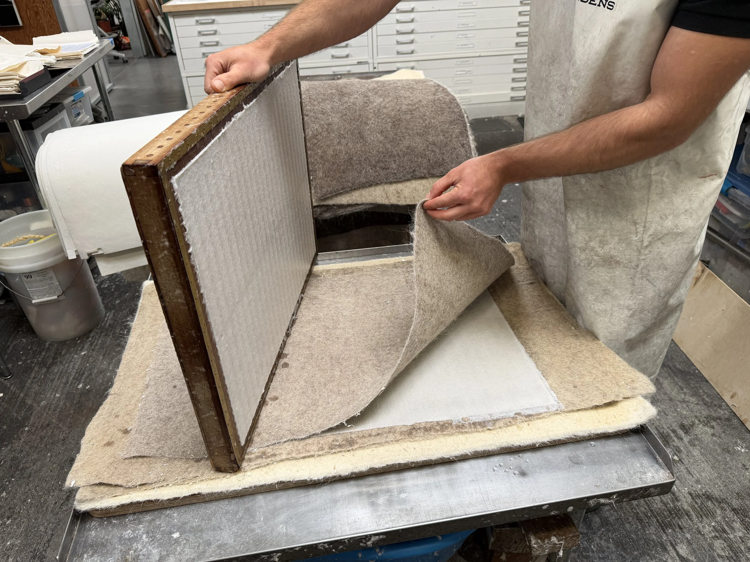 Magnolia Saper Studio: Attempting to make a percussion mark on a sheet by dropping the mould edge onto a felt-covered sheet