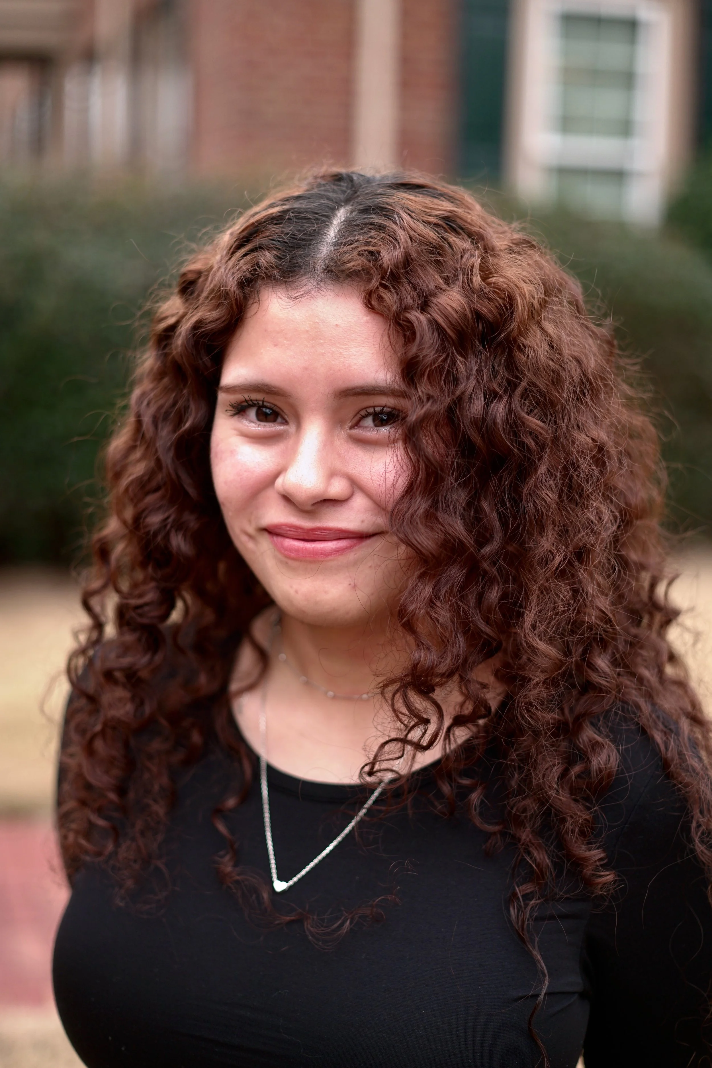 Close up picture of a curly hair female therapist
