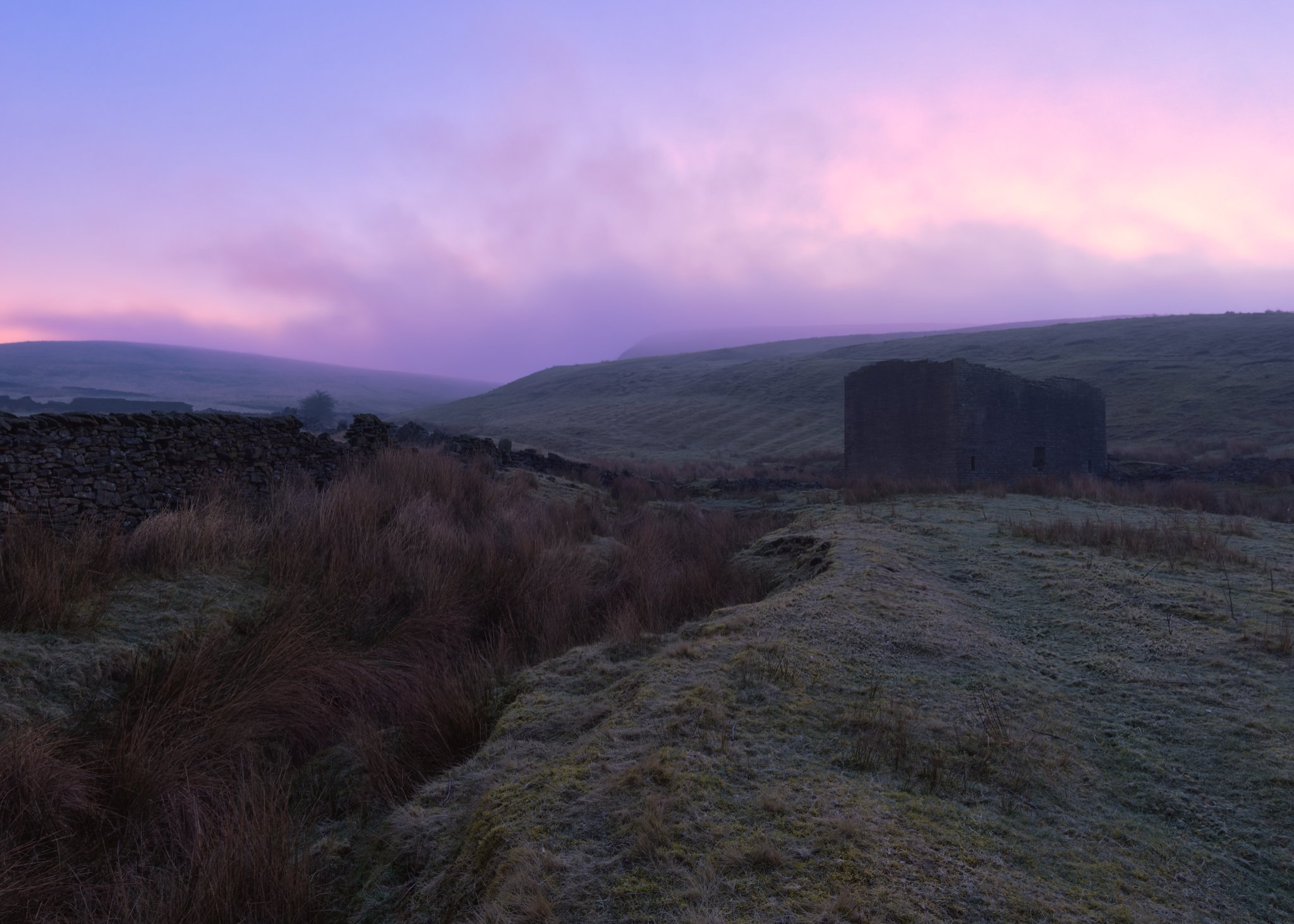Morning sunrise light breaking through clouds over the scenic hills of Naden Valley near Rochdale