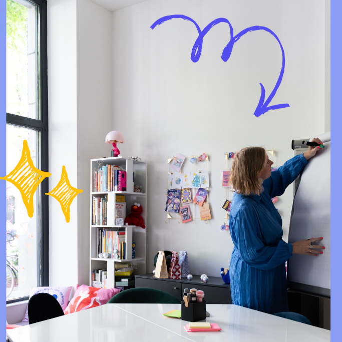 A woman writing on a flip chart