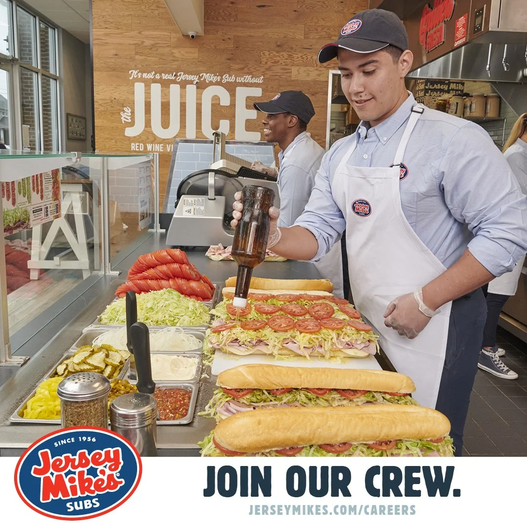 Jersey Mike's employee making sandwiches with ingredients like tomatoes, lettuce, and condiments. Advertisement promotes joining their crew with a link to their careers page.