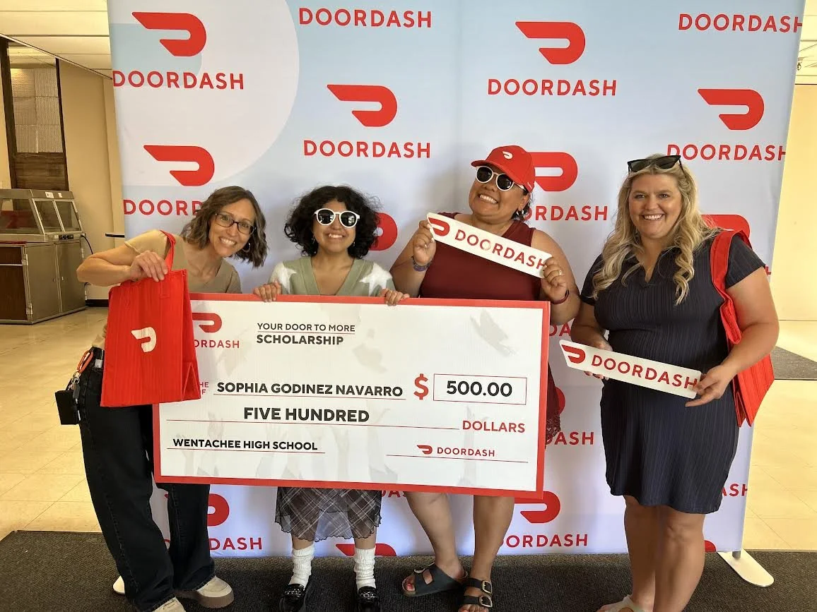 Teachers, students, and parents celebrate at a senior breakfast. One of the graduates received a scholarship from DoorDash!