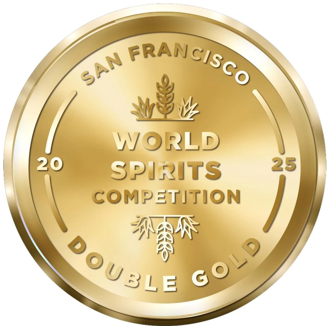 Gold medal with text reading 'San Francisco World Spirits Competition Double Gold 2025' and decorative wheat symbols.
