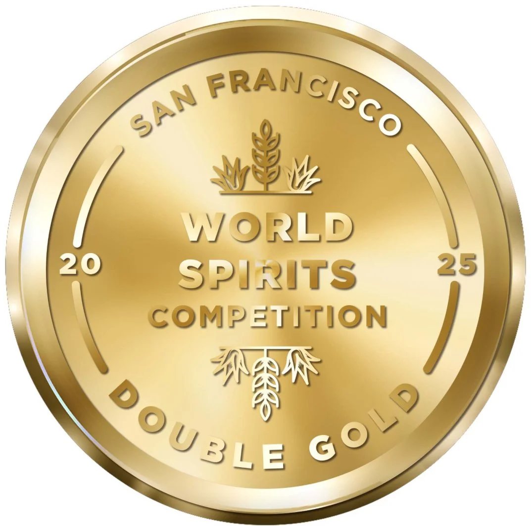 Gold medal or coin with text 'San Francisco World Spirits Competition Double Gold 2025' and decorative wheat symbols.