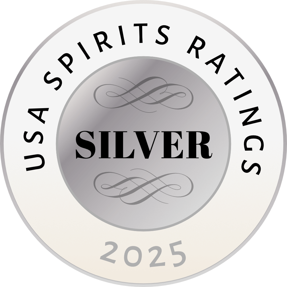 A circular emblem with a silver gradient background, featuring the text 'USA SPIRITS RATINGS' around the upper edge, the word 'SILVER' in bold in the center, decorative swirls above and below 'SILVER,' and the year '2025' at the bottom.