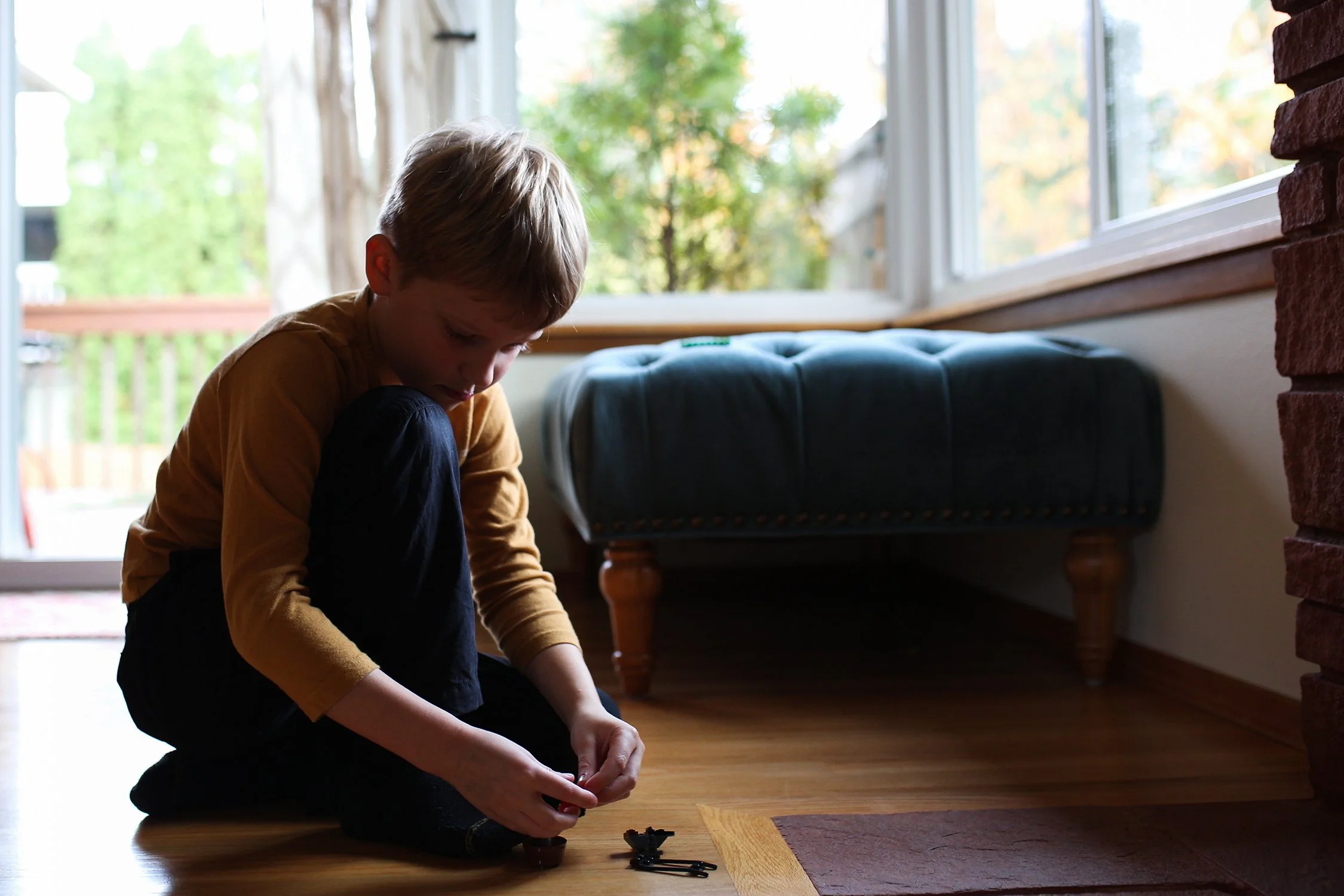 Boy playing with legos at home in living room