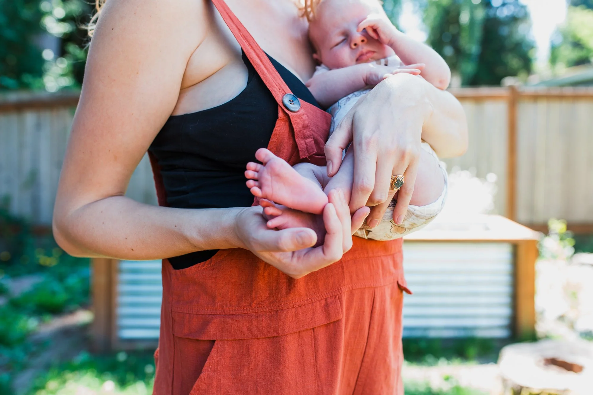 Shoreline new mother holding newborn baby in arms
