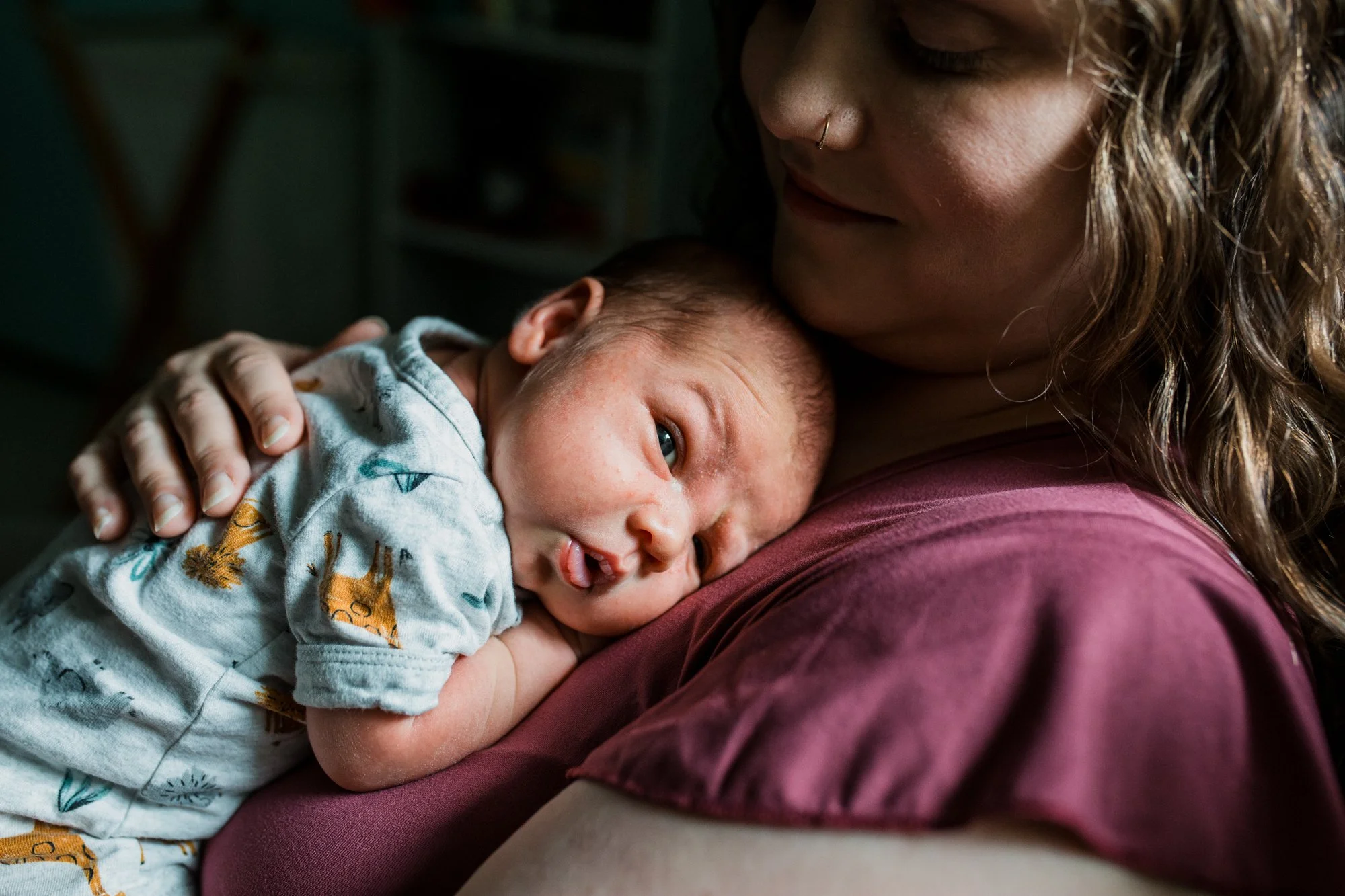 Newborn resting on mother during photo session