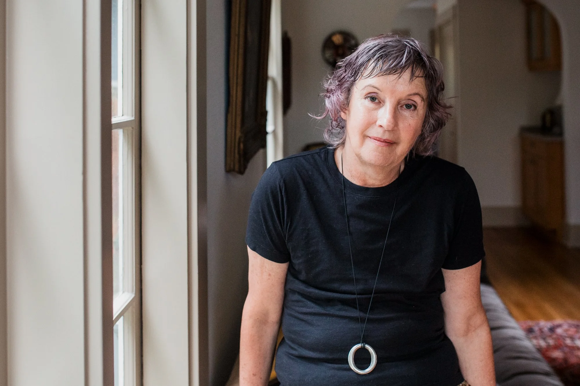 Seattle tarot reader sitting in home facing the camera