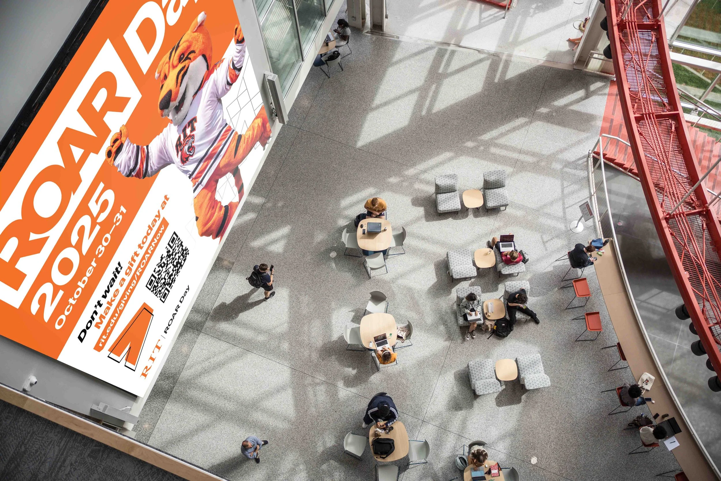 Overhead image of the SHED at RIT with a ROAR Day 2025 screen displayed.