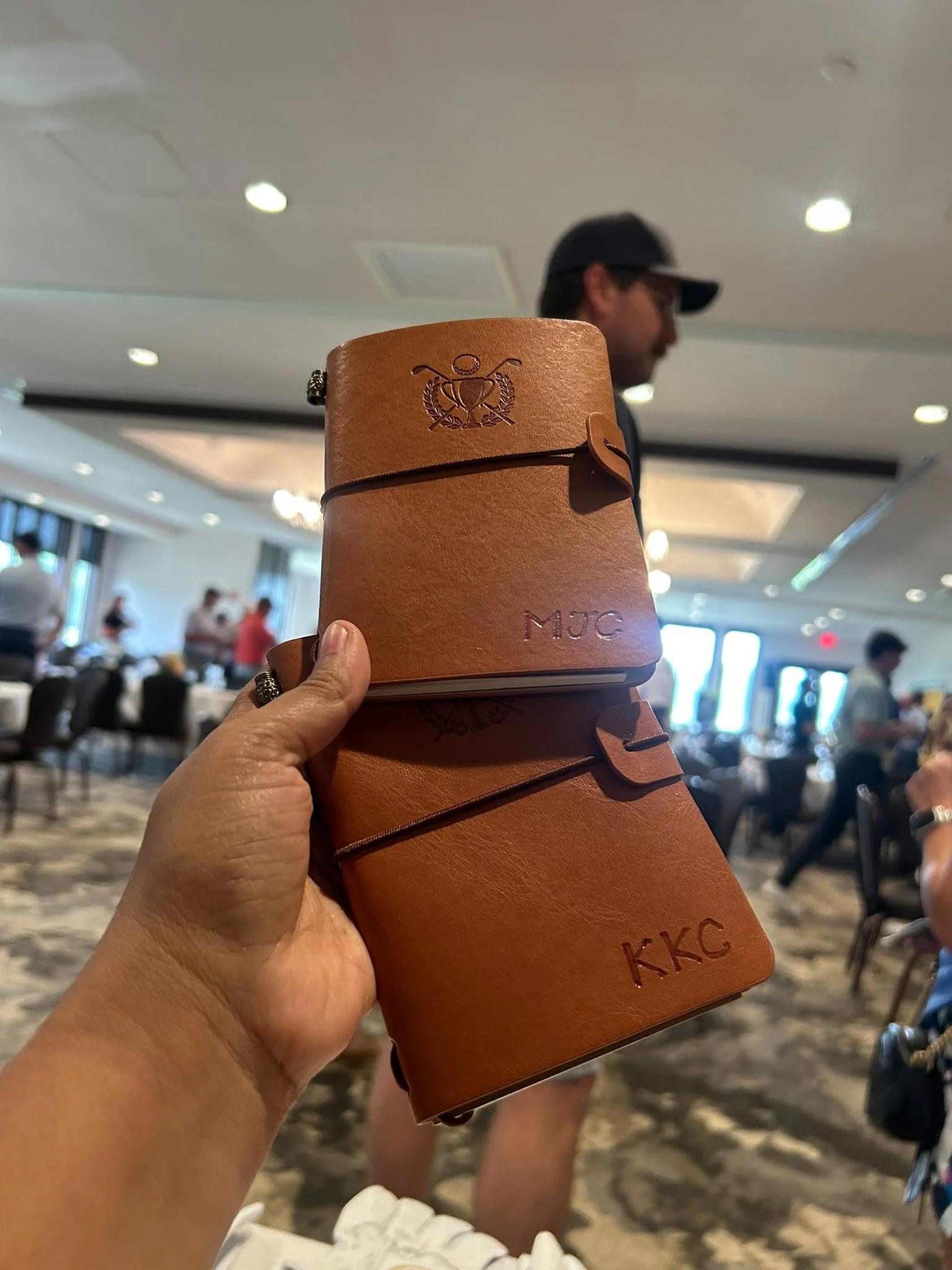 Personalized leather golf scorebooks customized live for guests at an AHEAD corporate golf event