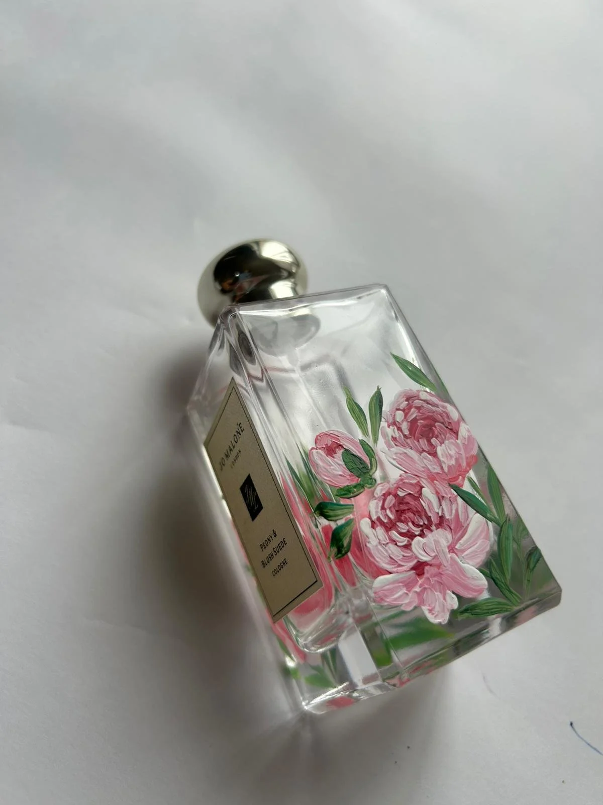 Hand-painted Jo Malone fragrance bottle with custom floral artwork for a luxury retail brand activation.