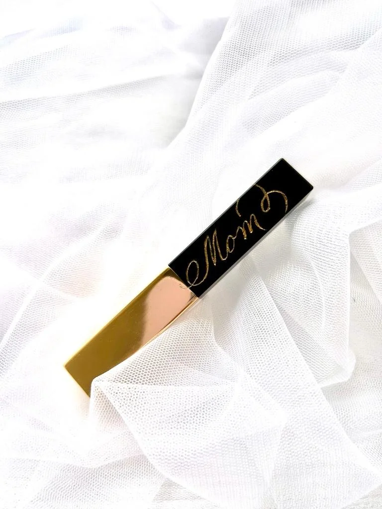 Live engraving on a YSL lipstick during a luxury brand activation event. Custom lipstick personalization for retail events, experiential marketing campaigns, beauty launches, and luxury customer experiences.