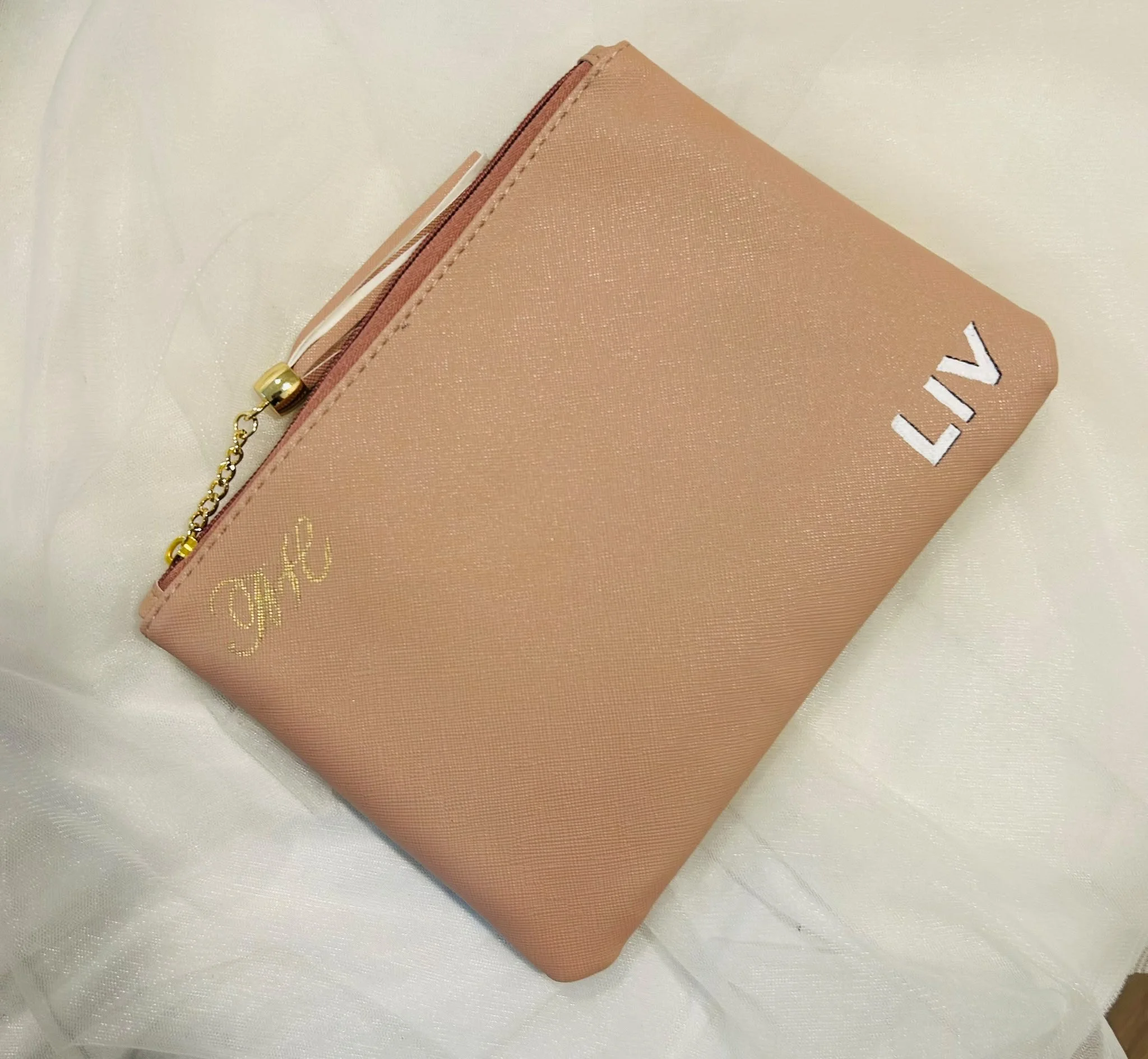 Personalized makeup bag with custom hand lettering for a live beauty brand activation