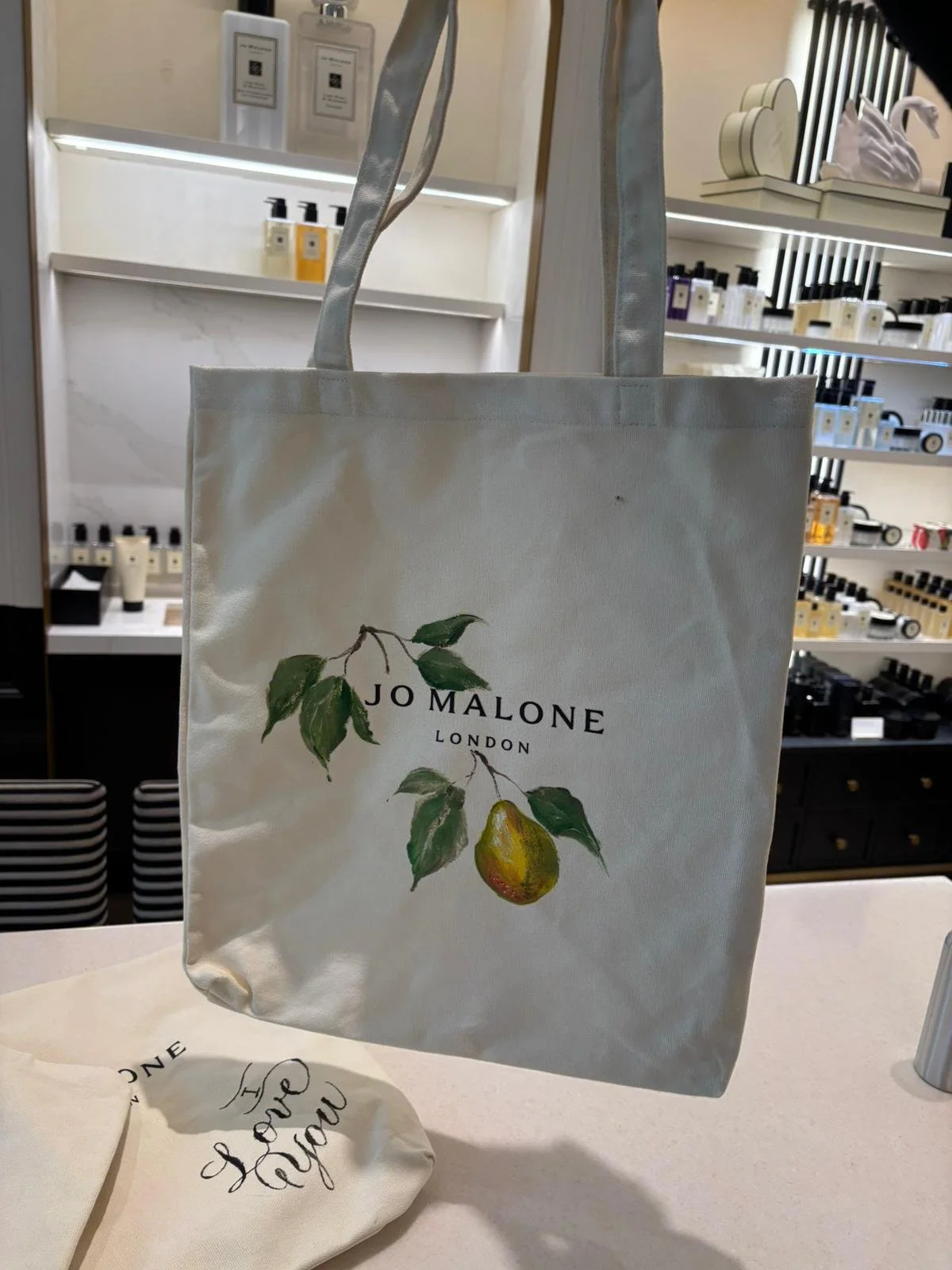 Hand-painted Jo Malone tote bag customized live for a luxury retail brand activation