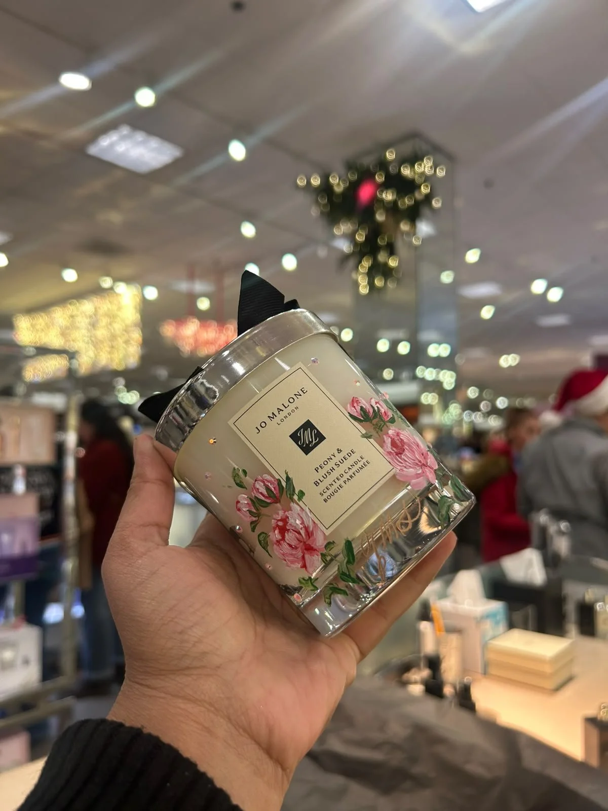 Hand-painted Jo Malone fragrance bottle with custom floral artwork for a luxury retail brand activation.