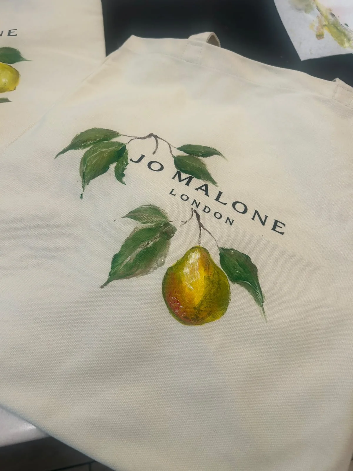 Hand-painted Jo Malone Bag with custom floral artwork for a luxury retail brand activation.