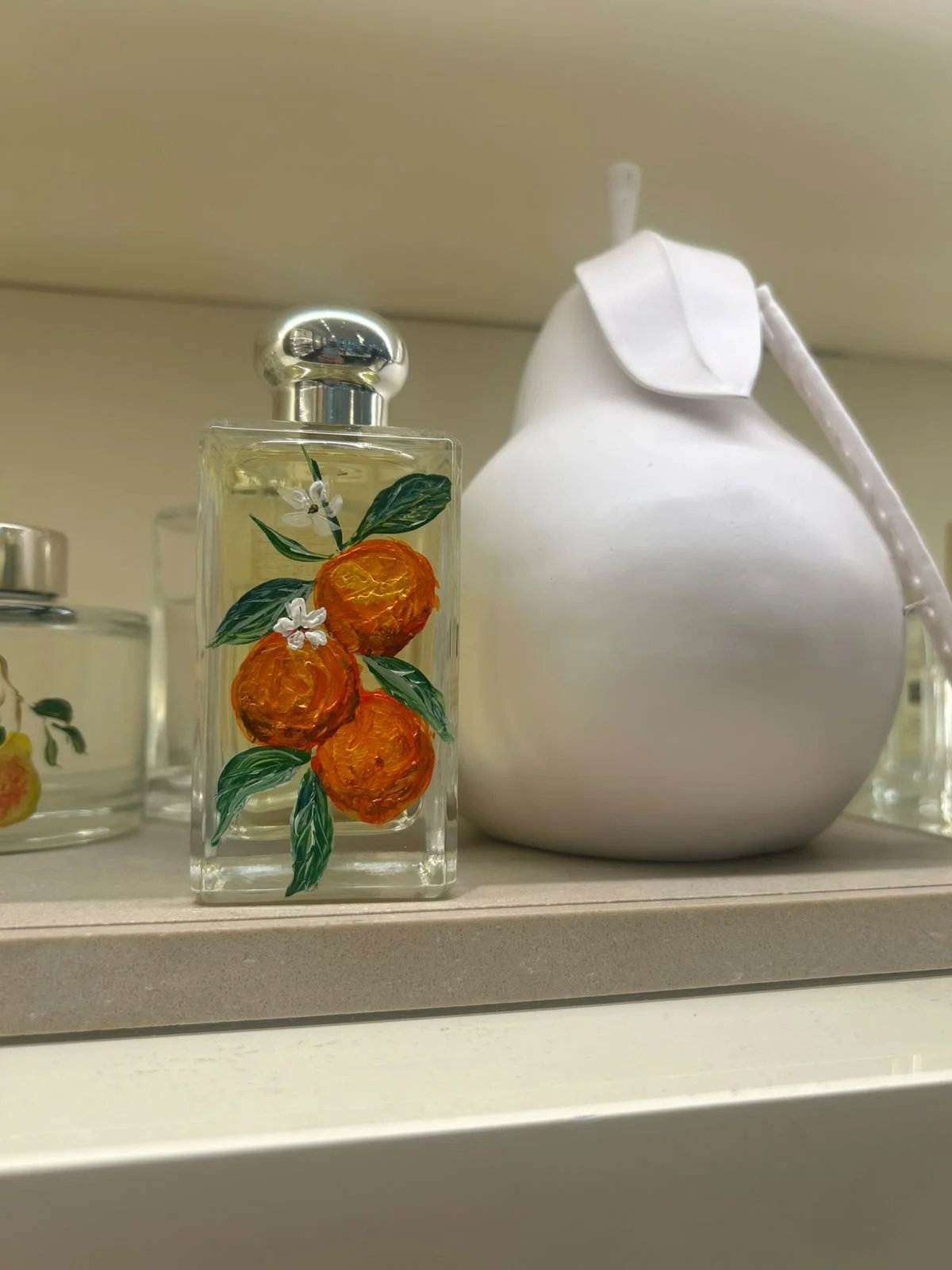 Hand-painted Jo Malone fragrance bottle with custom floral artwork for a luxury retail brand activation.
