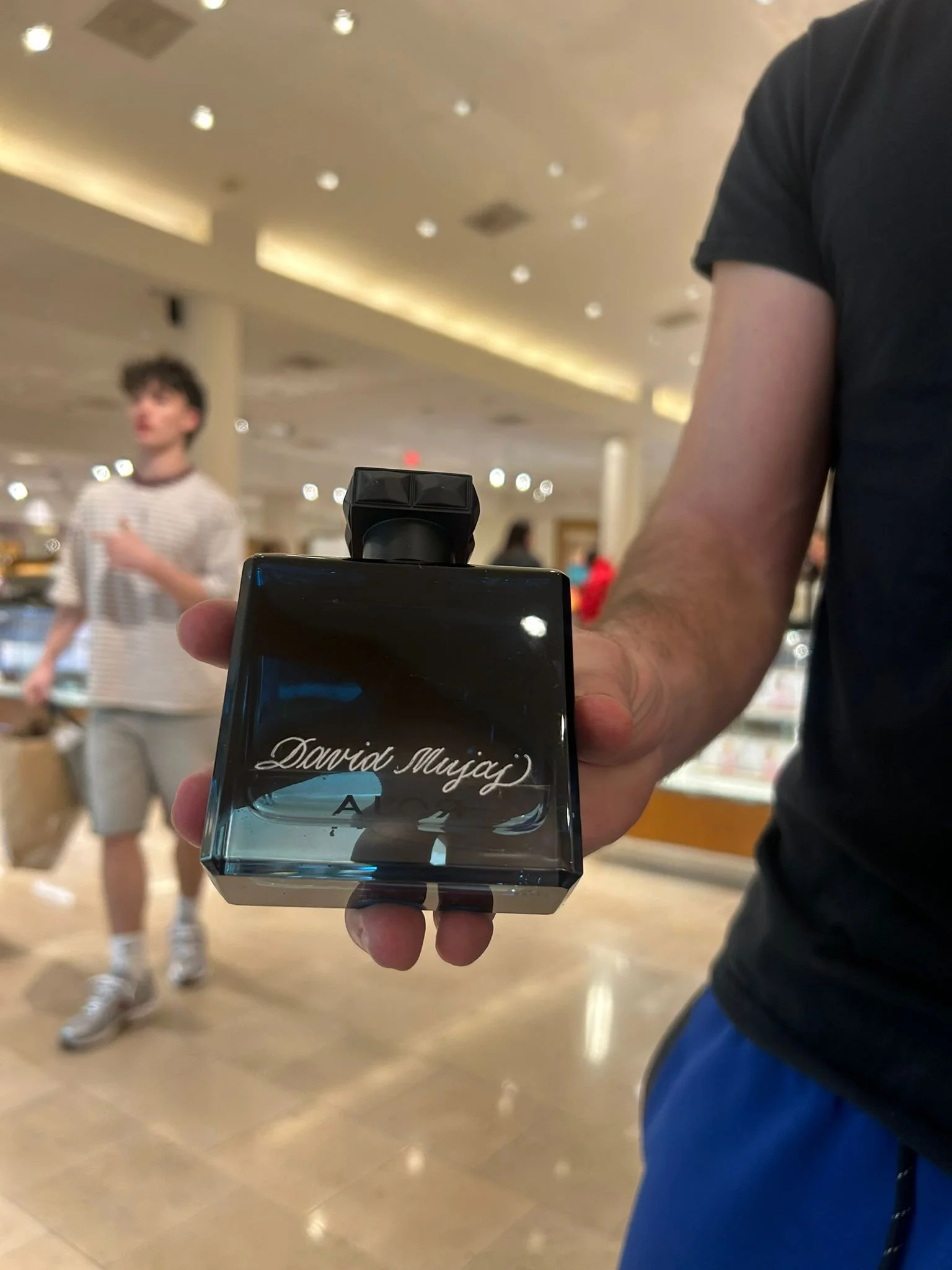 Live hand engraving of personalized initials on a luxury product during an in-store brand activation.