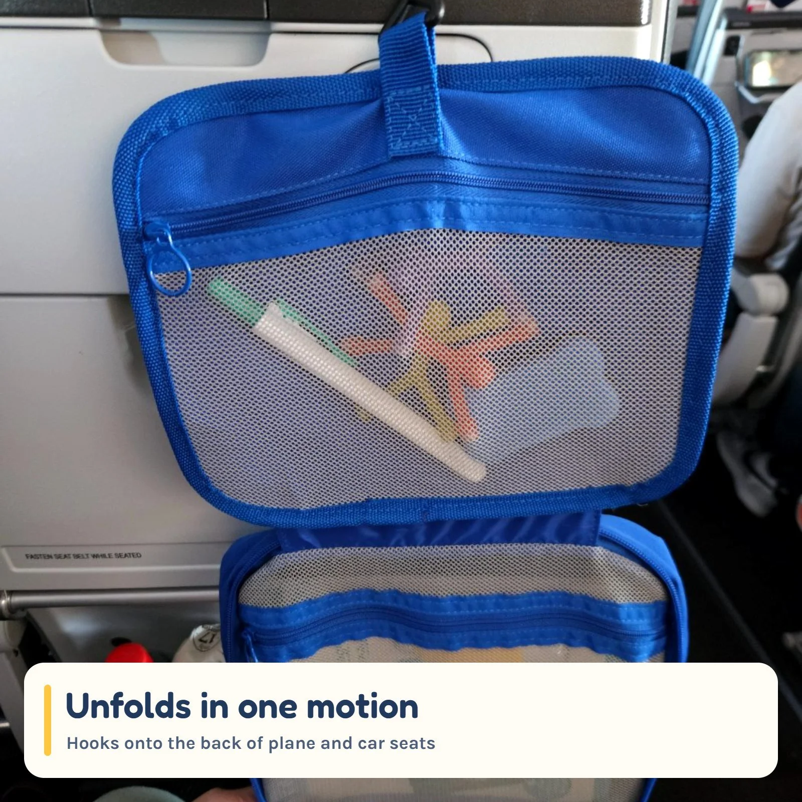 The kit hanging open from the back of a plane seat