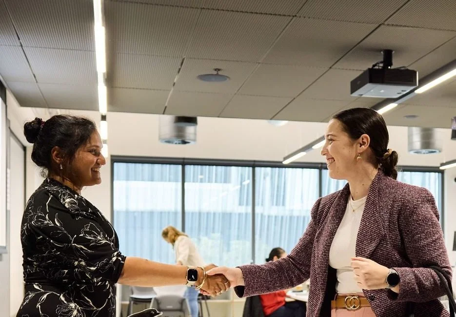 Brittany shaking hands with a fellow participant at the Curtin Ignition program