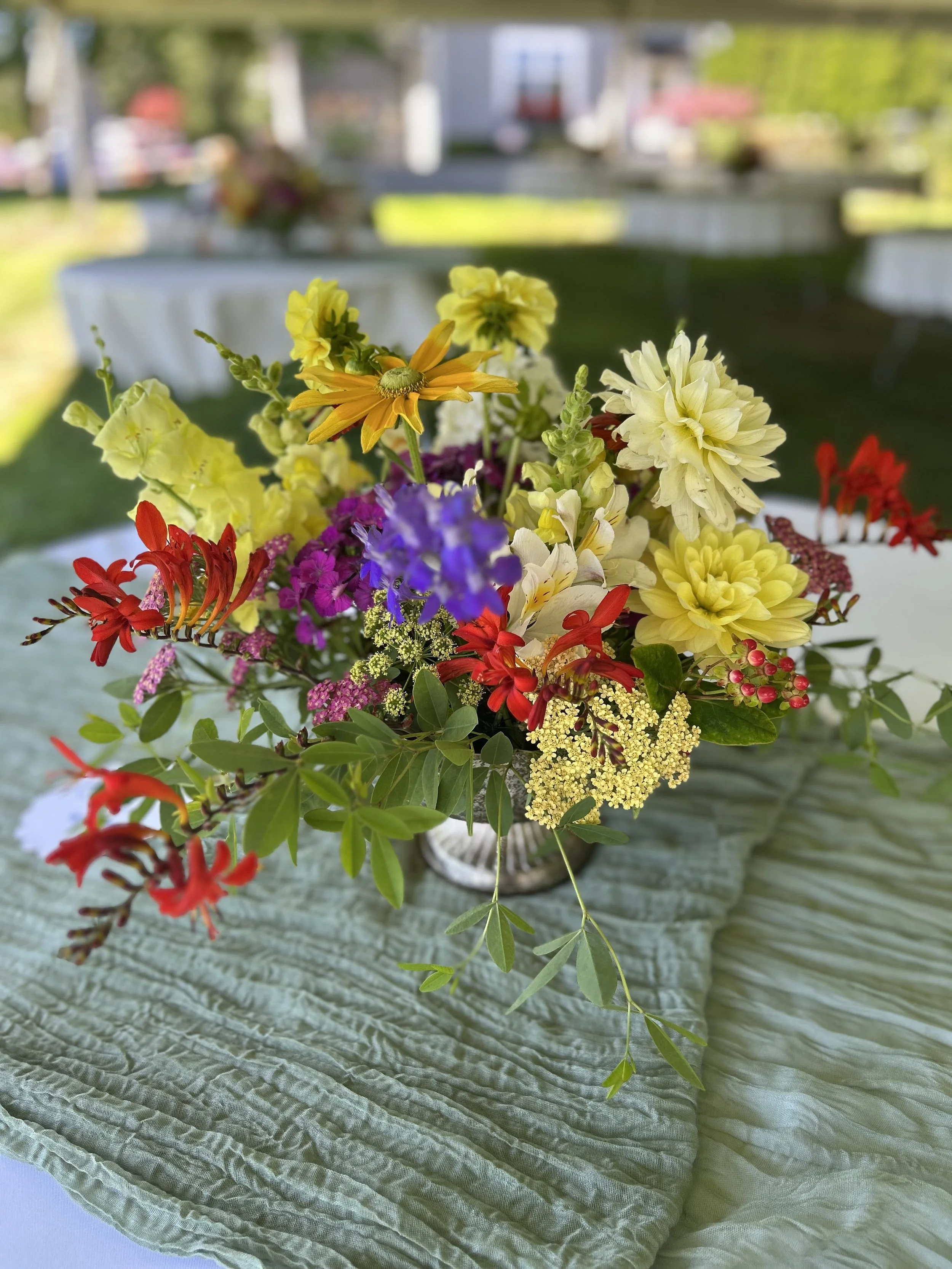 Colorful compote style table arrangement at wedding guest table.