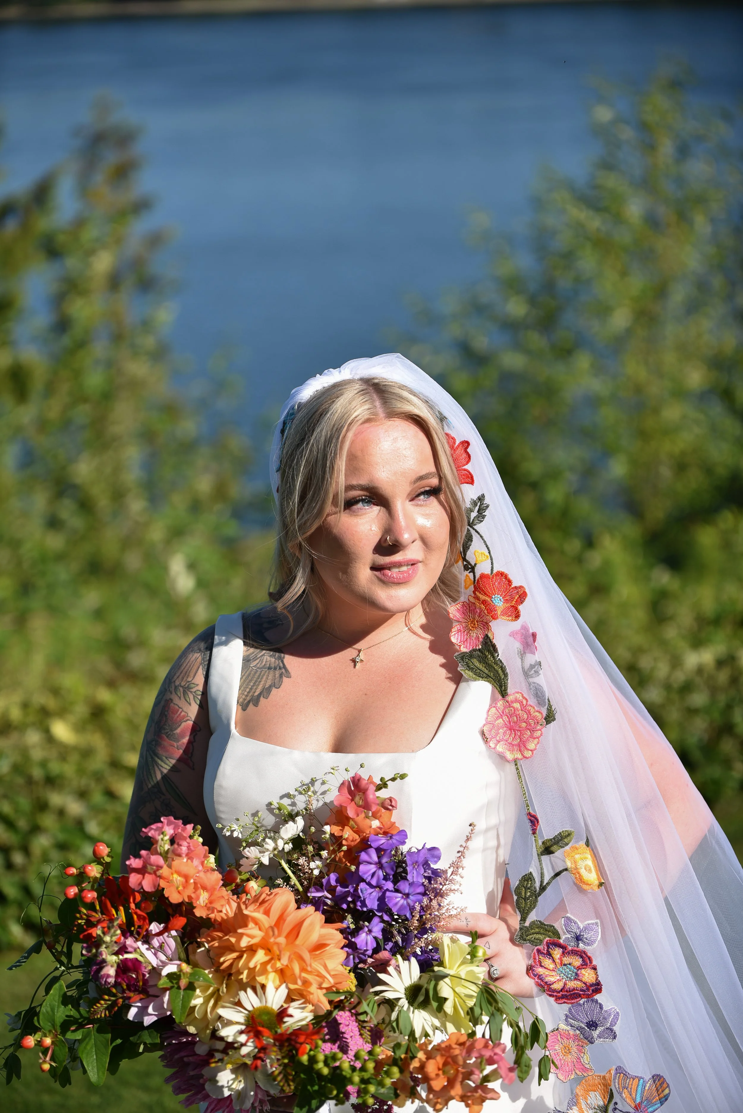 Large lush bridal bouquet with colorful dahlias, phlox, and many filler flowers.