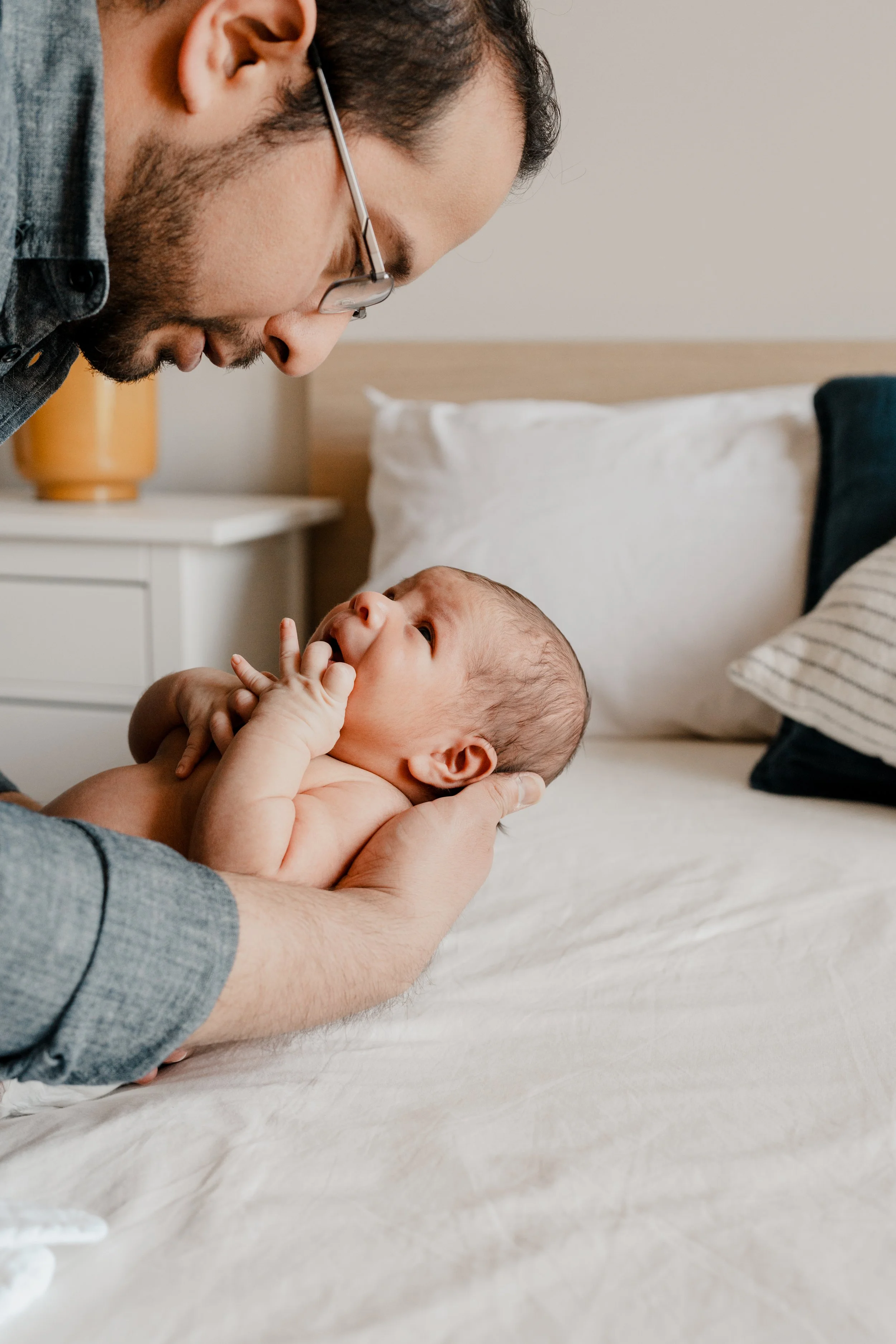 big sister snuggles new baby during lifestyle session with Fort Belvoir newborn photographer