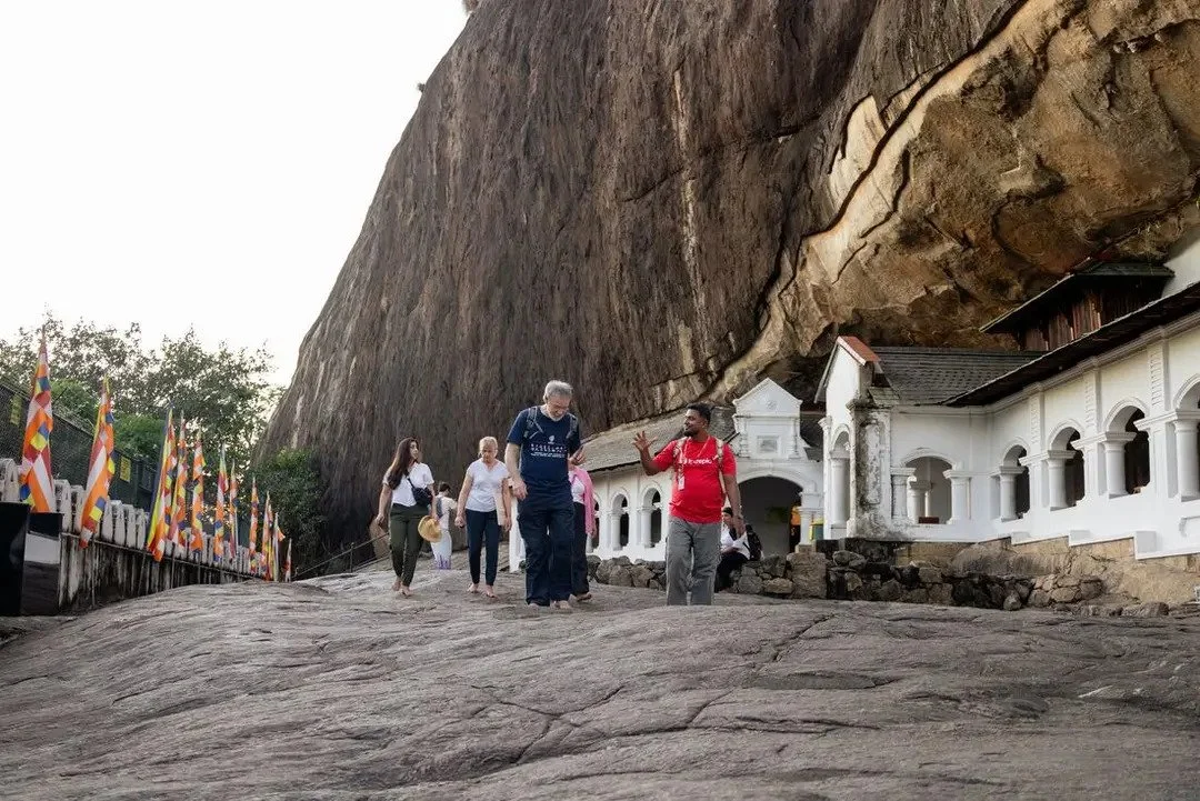 Asia Sustainable Travel - Intrepid-Travel-Sri-Lanka-Dambulla-Cave-Temple-group-walking-leader-Dodan-2.jpg