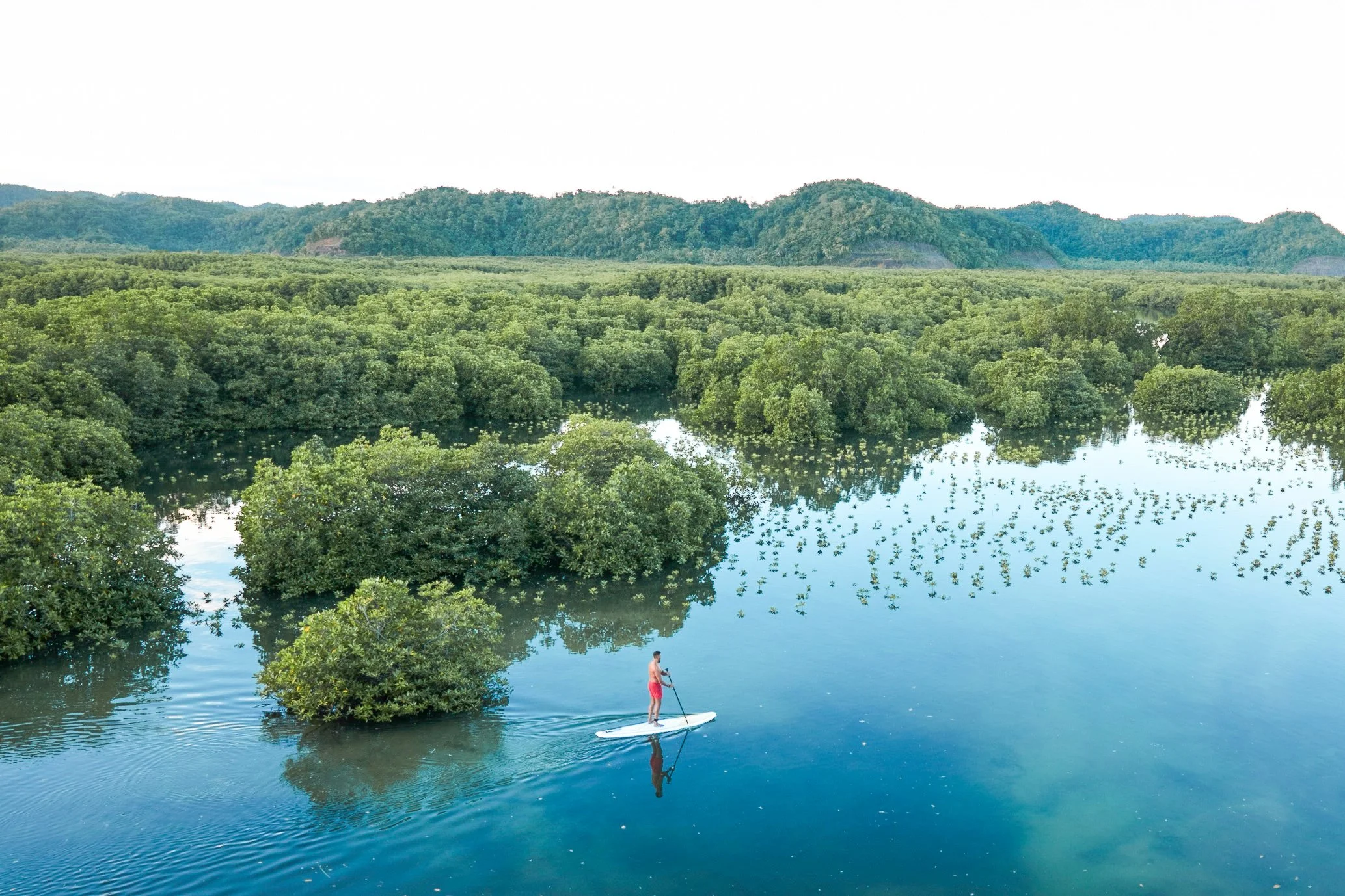 Barefoot Luxury Stand up paddling around the mangroves at Nay Palad Hideaway