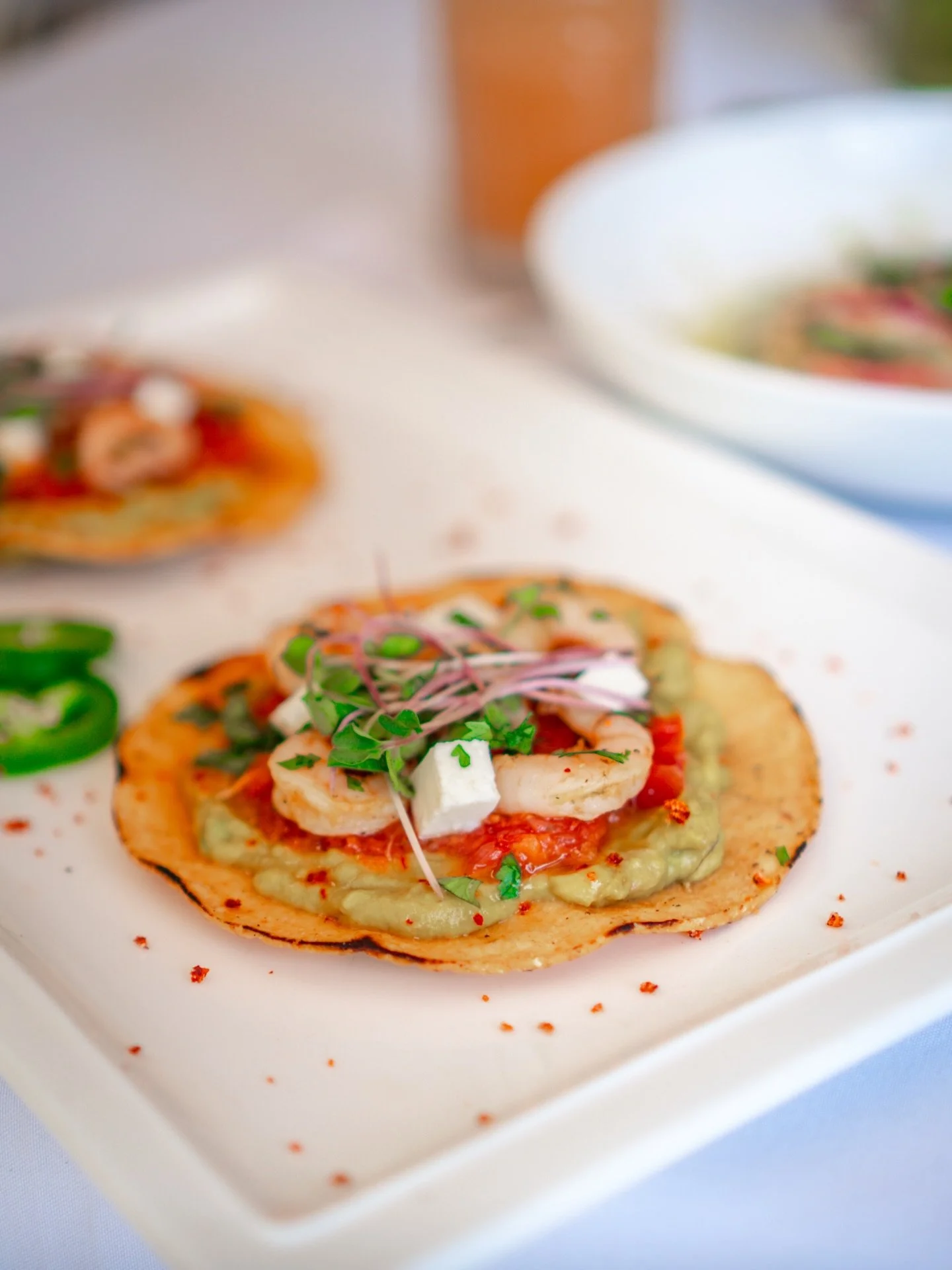 Crisp base. Fresh top.

Golden corn, layered with creamy, spicy, and bright notes, finished with pickled onions, herbs, and just the right hit of heat.

Every bite is contrast. Tostadas de crevettes.

#SGM26 #HaitiBites #FoodTexture #ModernMexican #C