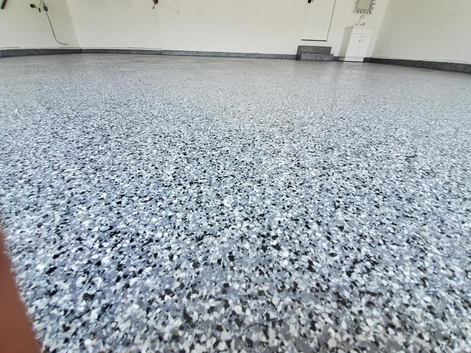 Garage with gray flake epoxy floor installed by Apex Epoxy Coatings