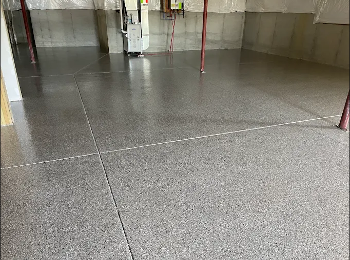 Concrete floor with visible expansion joints in an industrial or commercial setting.