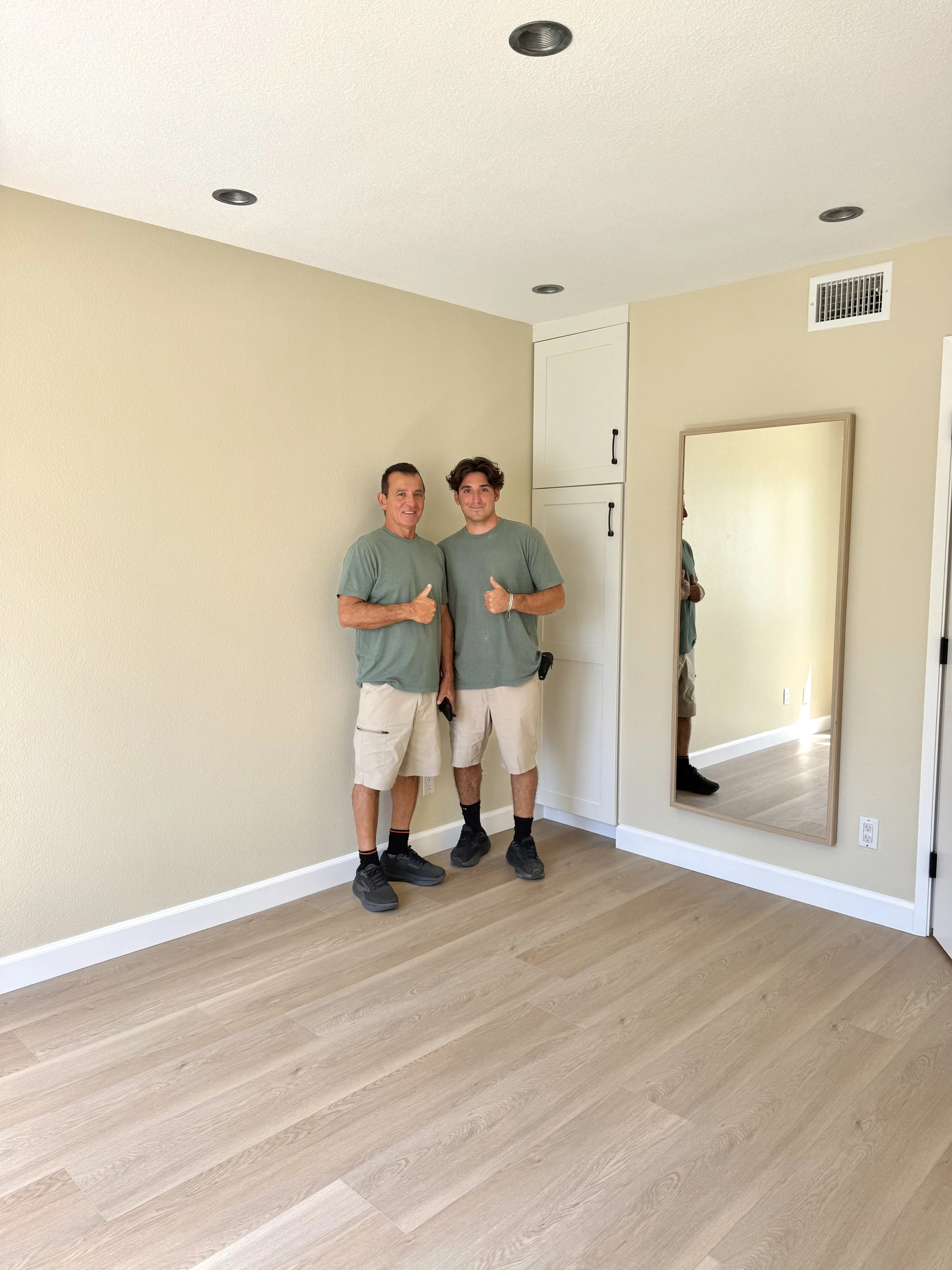 Mark and Charlie after completing a remodel that included new flooring and paint.