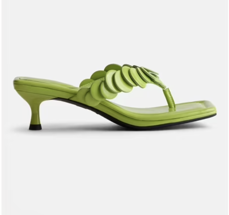 Low kitten heel thong sandals embellished with sparkling paillettes.