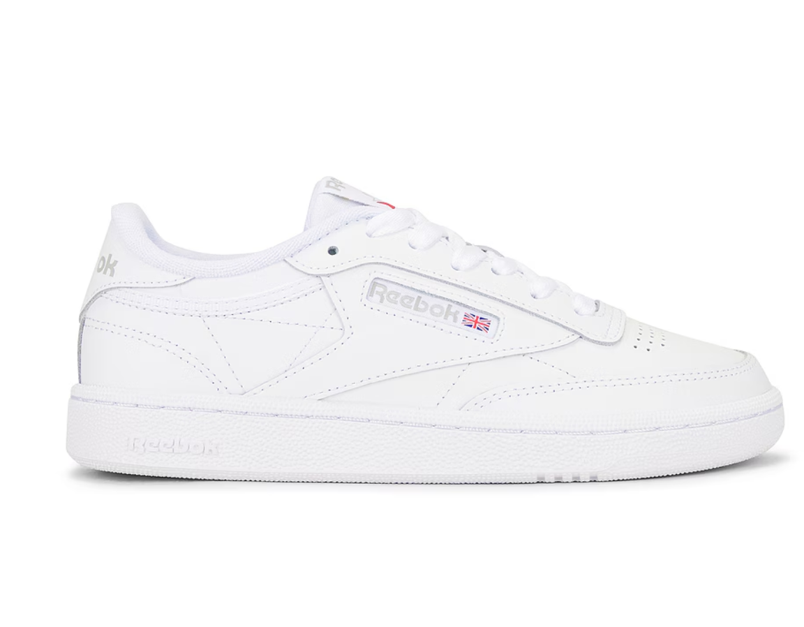 Side view of the white Reebok Club C 85 women's sneaker featuring a soft leather upper, vintage-inspired logo, and a low-cut design for a classic court look.