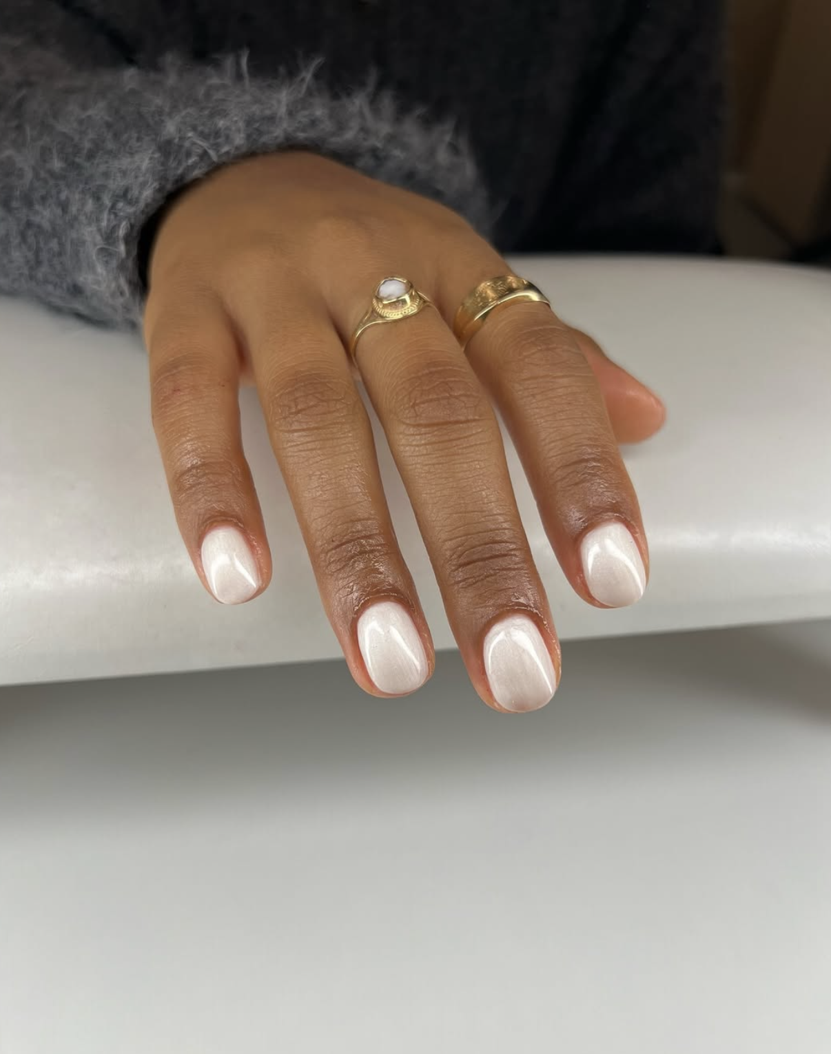 Short pearl white chrome nails with a soft glazed finish