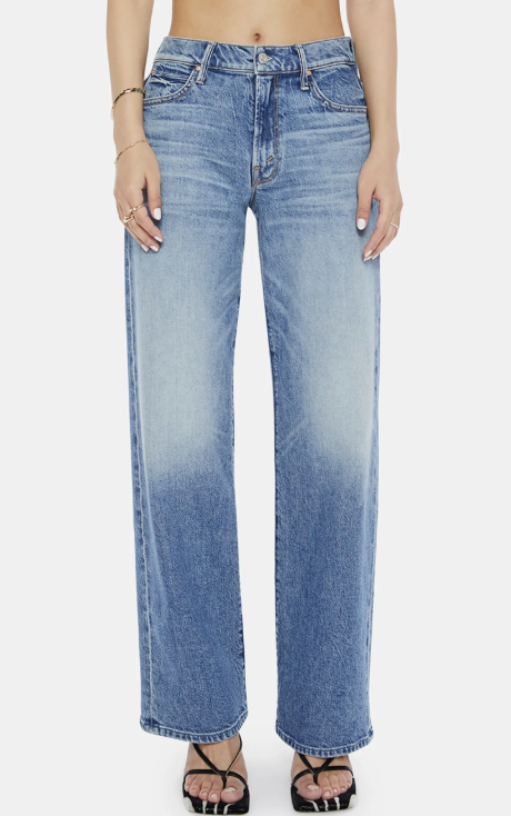 A product photo of the MOTHER Lil' Tunnel Vision Sneak Wide Leg Jeans in a light-blue wash, featuring a high-rise waist and a long, wide-leg silhouette that pools slightly at the hem.