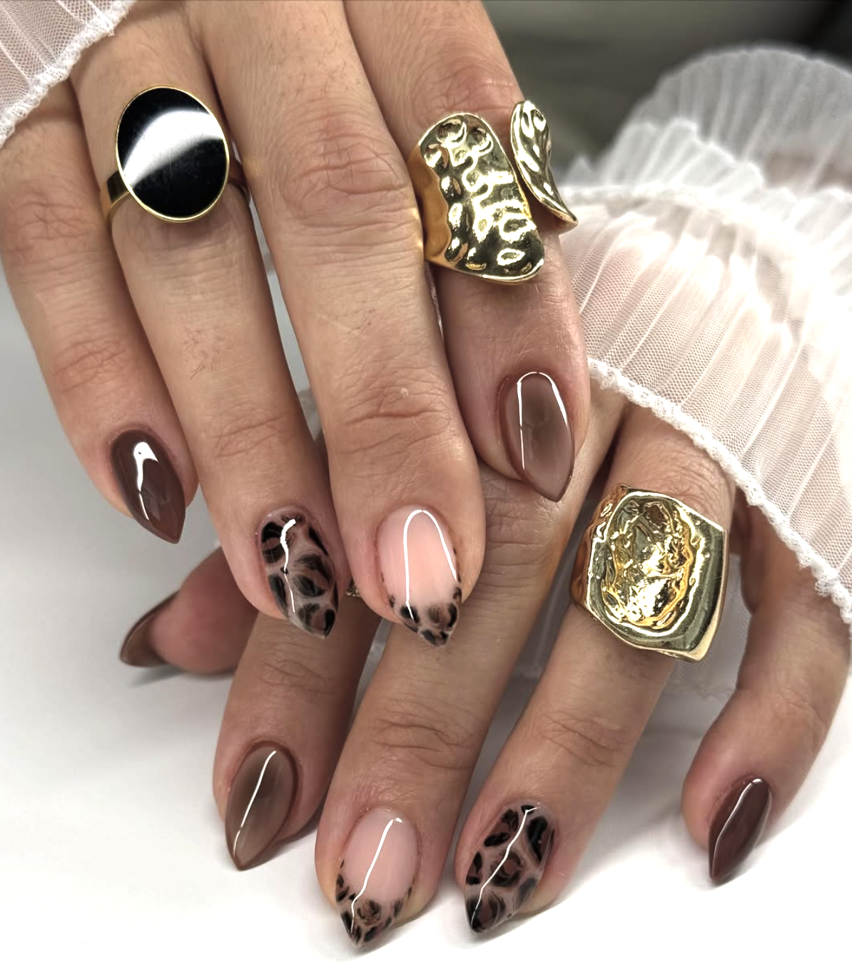 Close-up of leopard micro tips on neatly manicured hands