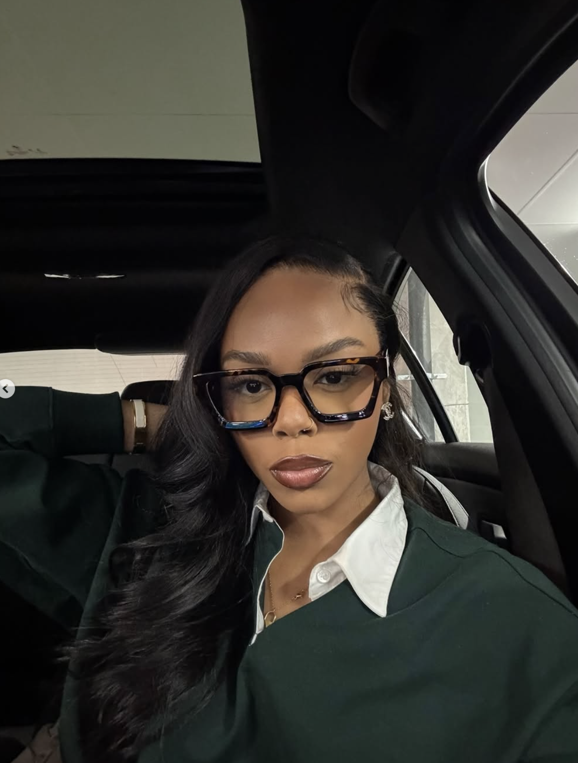 Woman with an oval face shape wearing eyeglasses, styling inspiration for oval face frames.