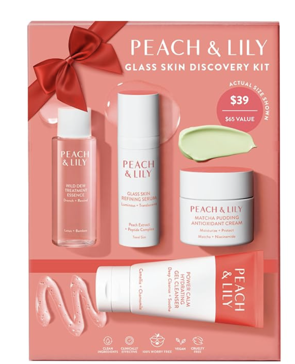 Peach & Lily Glass Skin Discovery Kit packaged in a pink gift box with a red ribbon, featuring four travel-size skincare products including essence, serum, cleanser, and moisturizer.