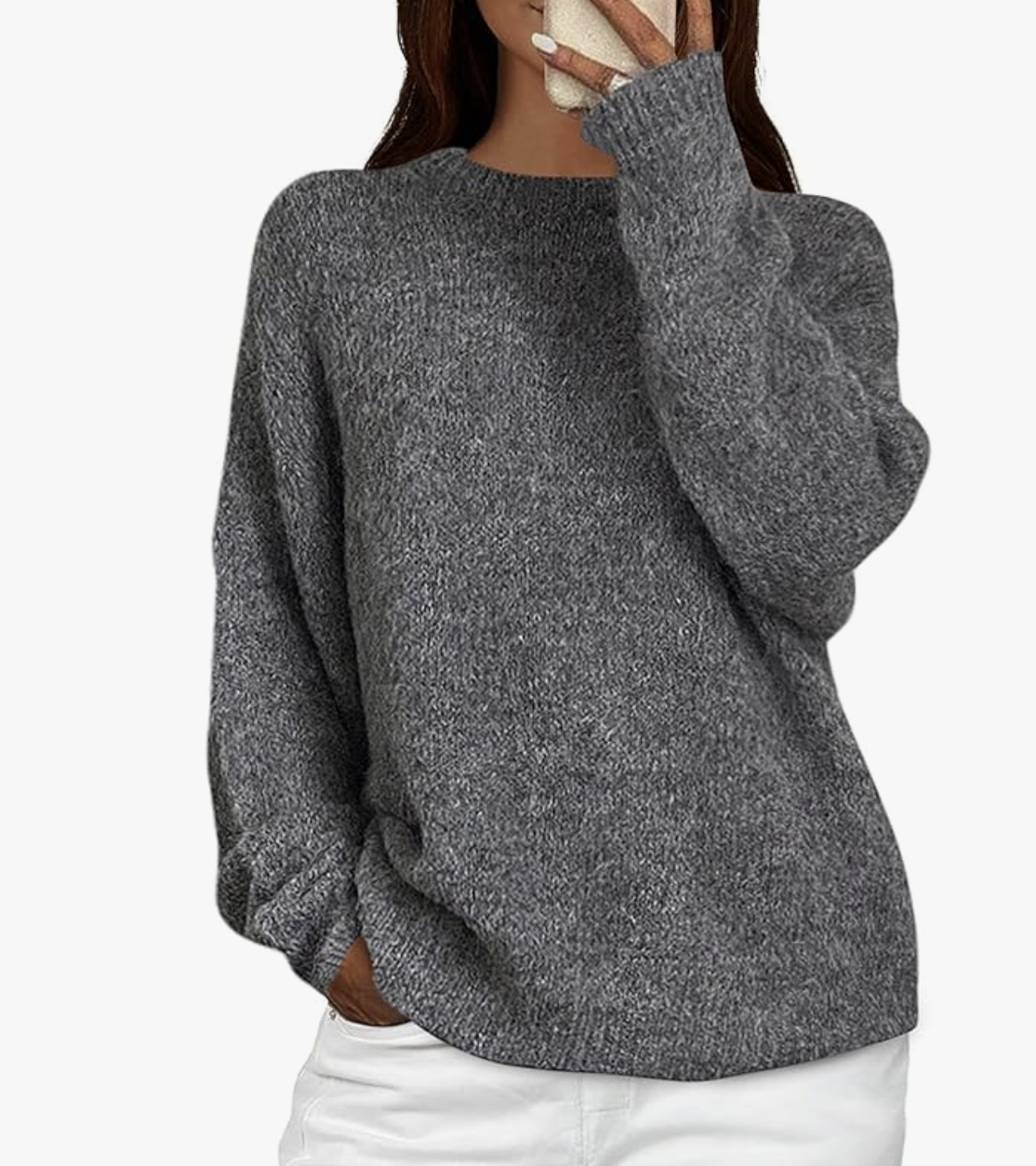 A close-up of a women's long-sleeve grey crewneck sweater from Amazon, styled with white jeans for a polished fashion editor-inspired outfit.